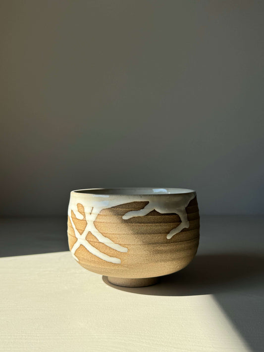 Handmade Matcha bowl from Yuki Series, featuring toffee clay with white glaze drips, adding rustic charm and uniqueness.