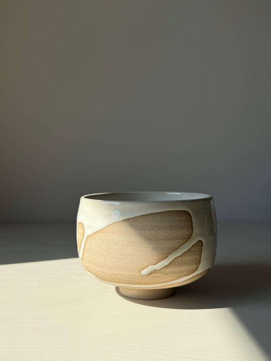 Handmade Matcha bowl from Yuki Series with toffee clay and white glaze, showcasing unique drip pattern, perfect for calming rituals.