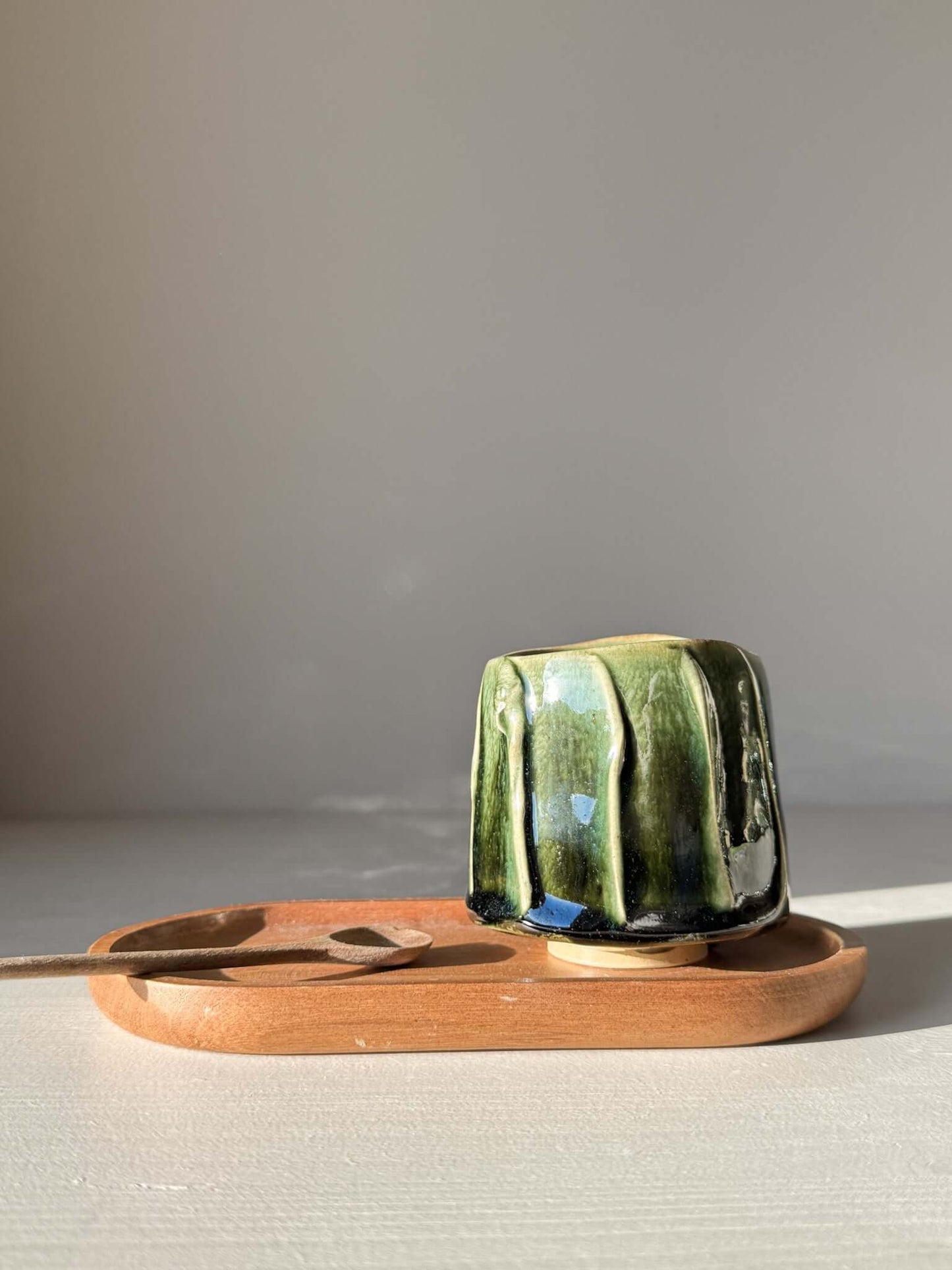 Yunomi Cup - Hinoki #15 with deep green glaze, hand-decorated slip texture on a wooden serving tray, ideal for tea moments.