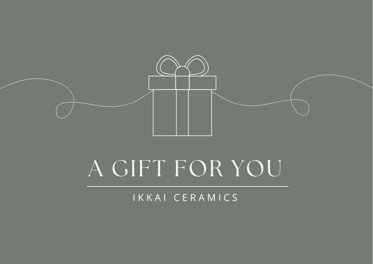 IKKAI Ceramics gift card image with a decorative wrapped gift box and the text 'A Gift for You' on a stylish background.