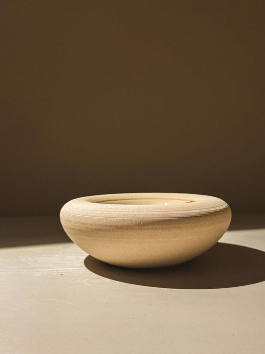 Minimalist handmade stoneware double-walled bowl in toffee-toned clay with soft lines, part of the Inyo Series collection.