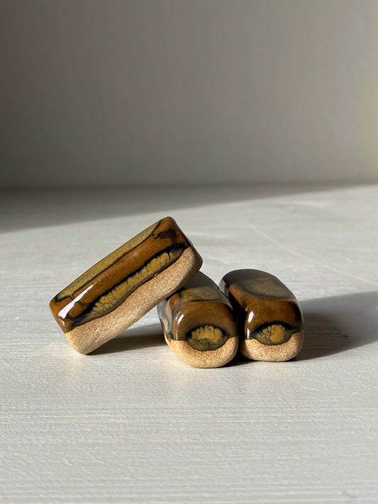 Handmade ceramic Chopstick/Spoon Rest – Inyo with glossy Tenmoku glaze, perfect for enhancing dining aesthetics.