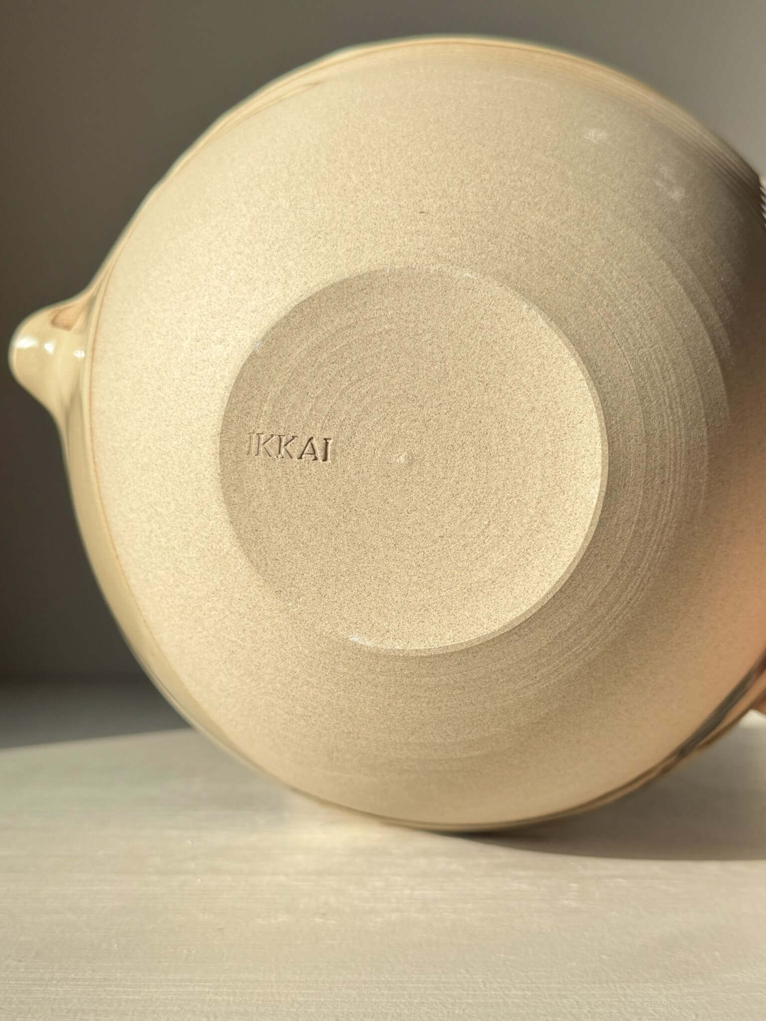 Base view of Pouring Bowl – Inyo in warm toffee clay, showcasing craftsmanship.