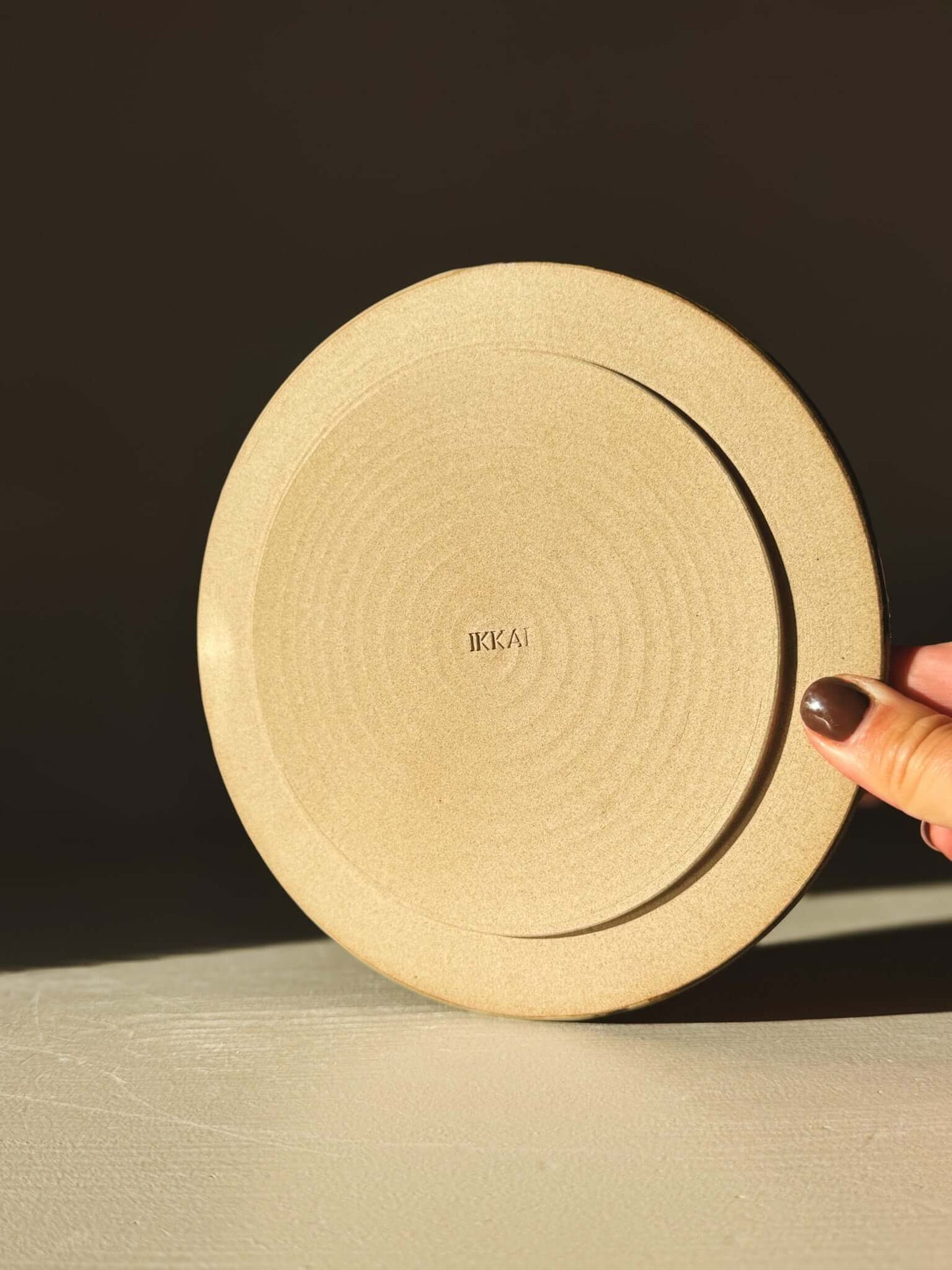 Side Plate – Inyo with a creamy and tenmoku swirl design, perfect for meals and snacks, displayed on a table.