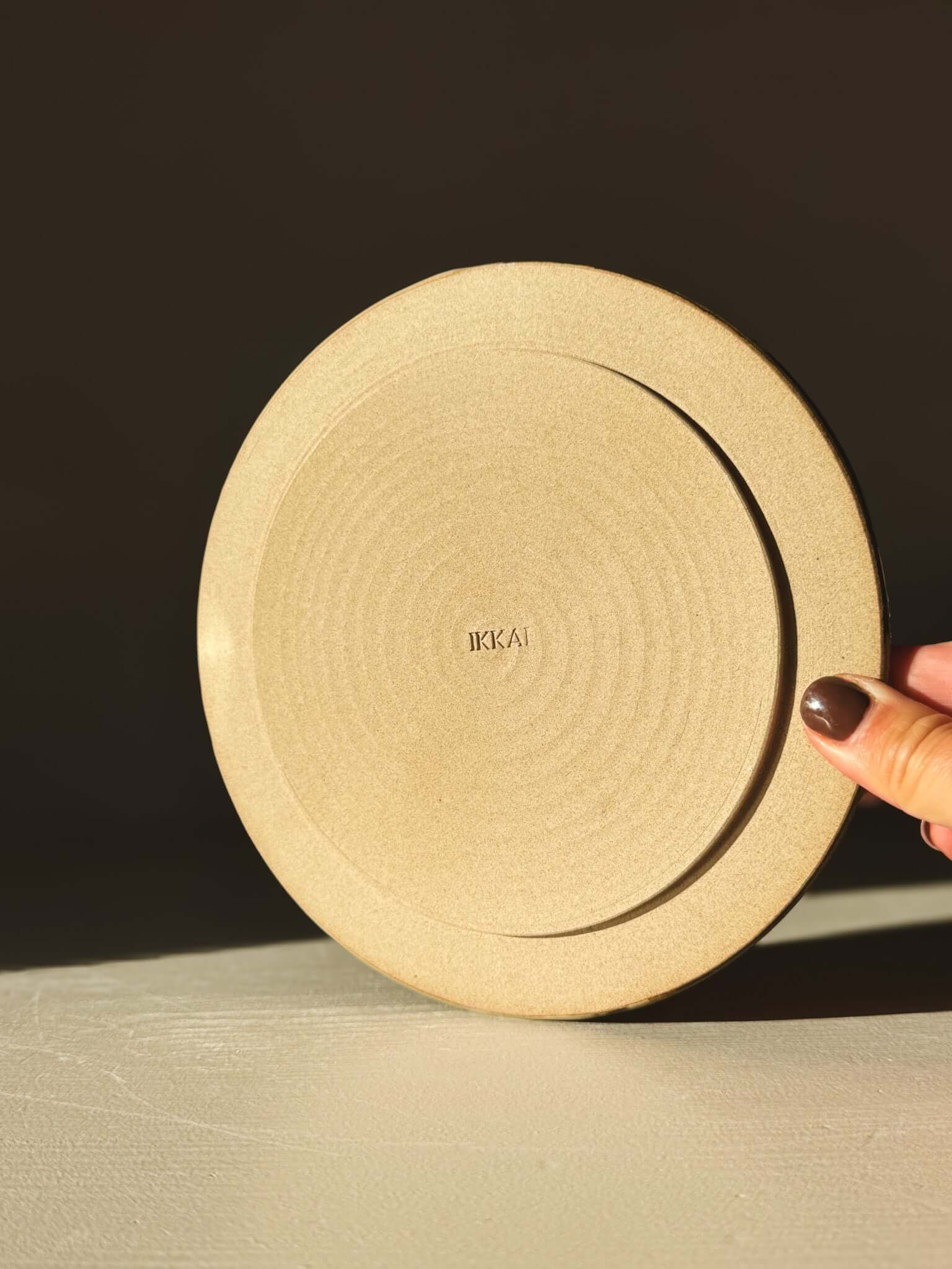 Side Plate – Inyo with a creamy and tenmoku swirl design, perfect for meals and snacks, displayed on a table.