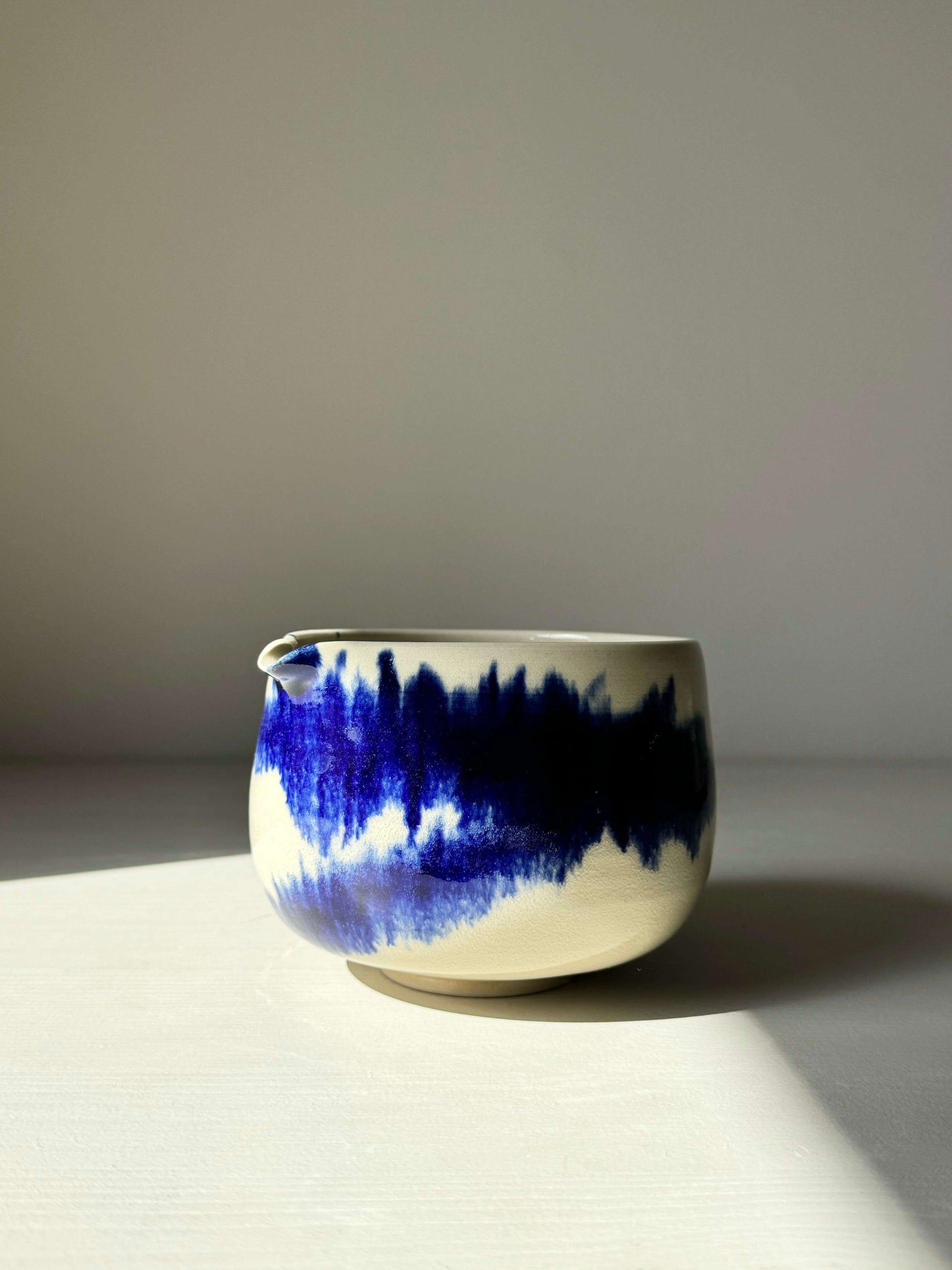 Katakuchi Matcha Bowl with cobalt blue glaze in dynamic patterns from the Gosu Series, featuring a unique spout design.