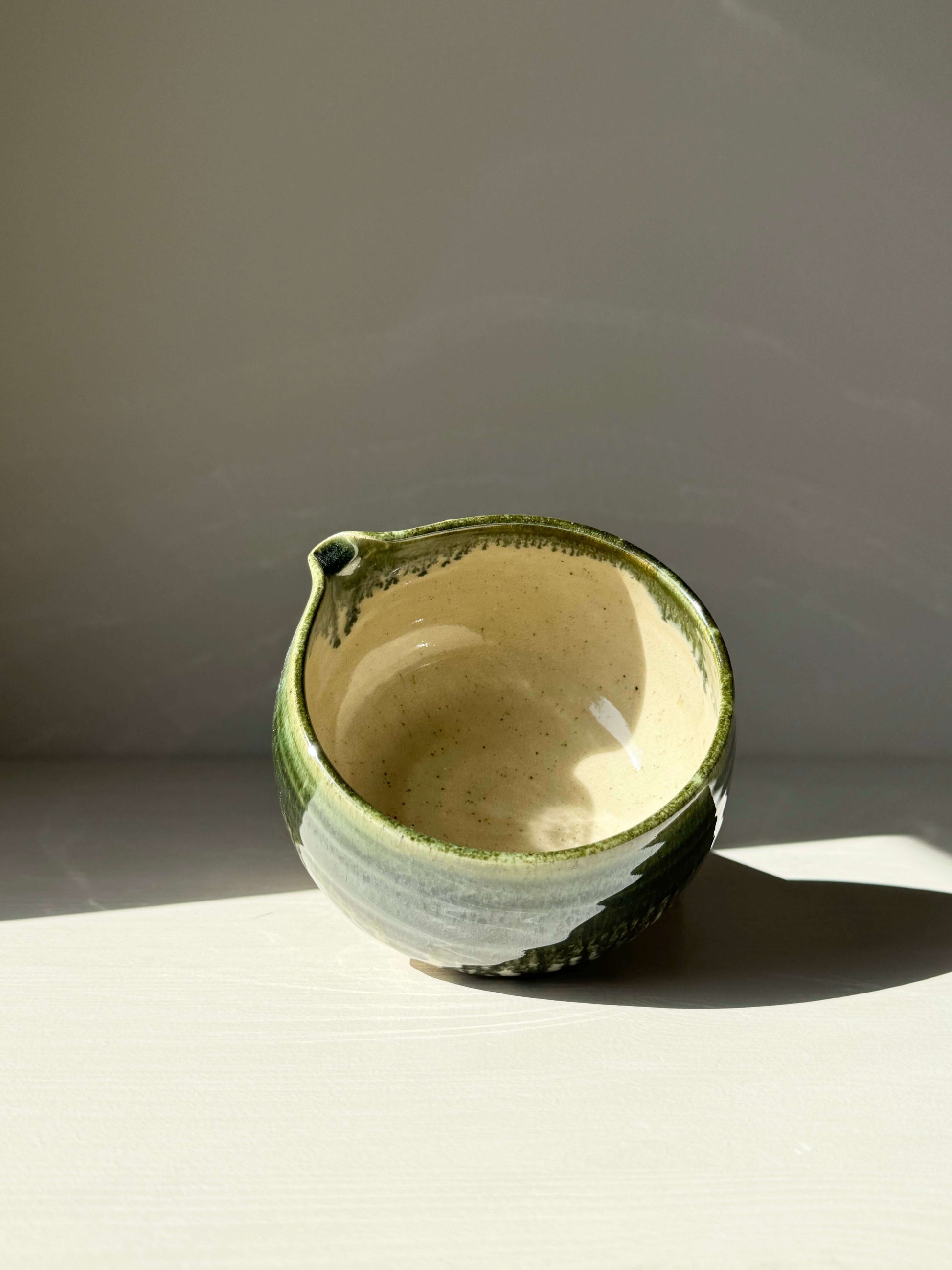 Katakuchi Matcha Bowl with a spout, featuring a green rim and a smooth finish, ideal for whisking and pouring traditional Japanese matcha.
