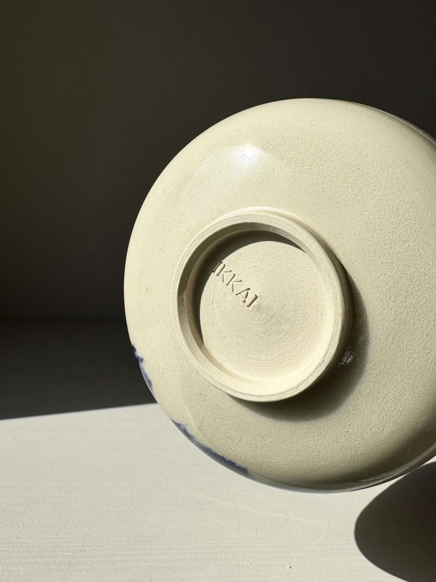 Bottom view of Katakuchi Matcha Bowl, part of Gosu Series, showing maker's mark 'RAKAI' embossed on base.