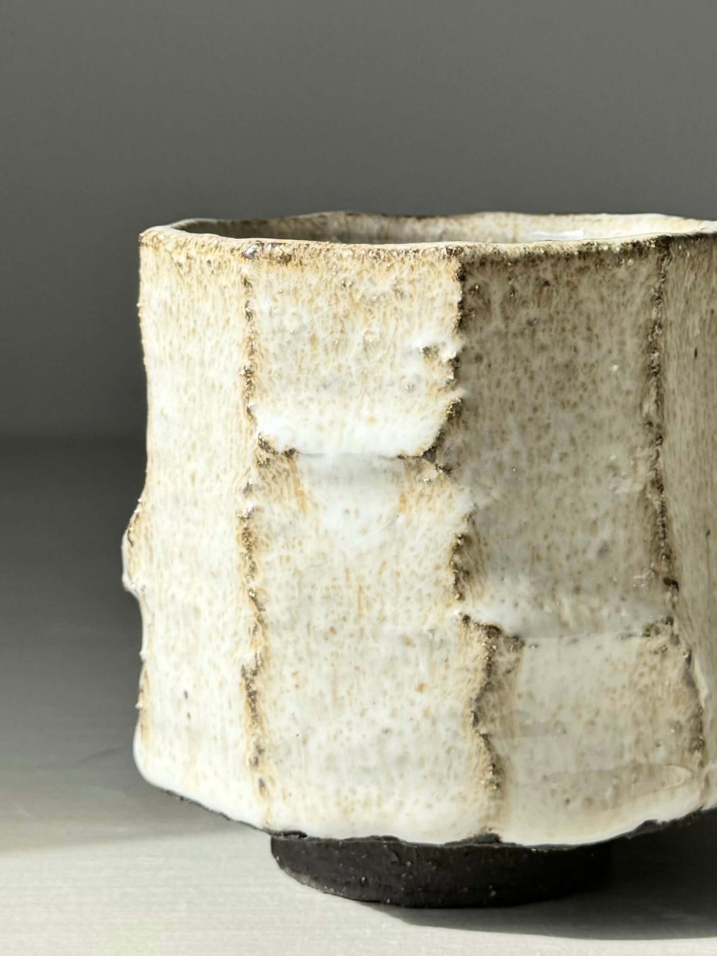 Kurinuki style cup with nuka glaze, featuring a hand-carved, textured surface. A unique blend of wheel-thrown and carved pottery.