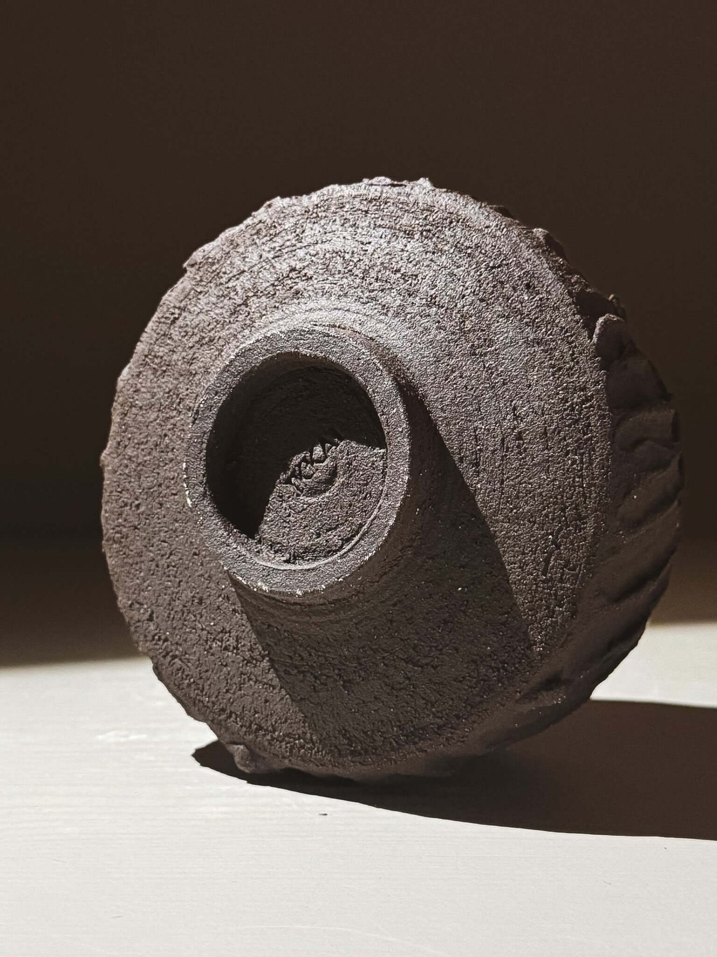 Kuro Matcha Bowl #03 displaying textured dark brown slip and glossy interior, inspired by volcanic stone and earthy tones.