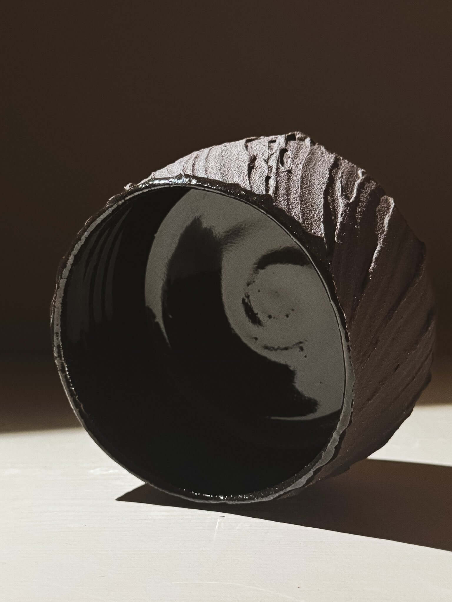 Kuro Matcha Bowl #07 with textured dark brown exterior and glossy inside, inspired by volcanic stone and earthy textures.