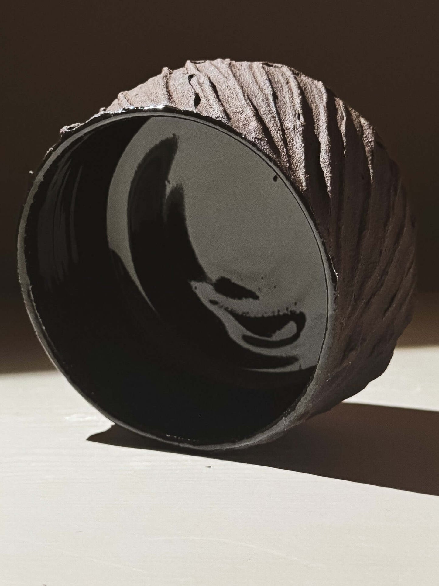 Kuro Matcha Bowl #01 with textured dark brown exterior and glossy black interior inspired by volcanic stone and earthy textures.