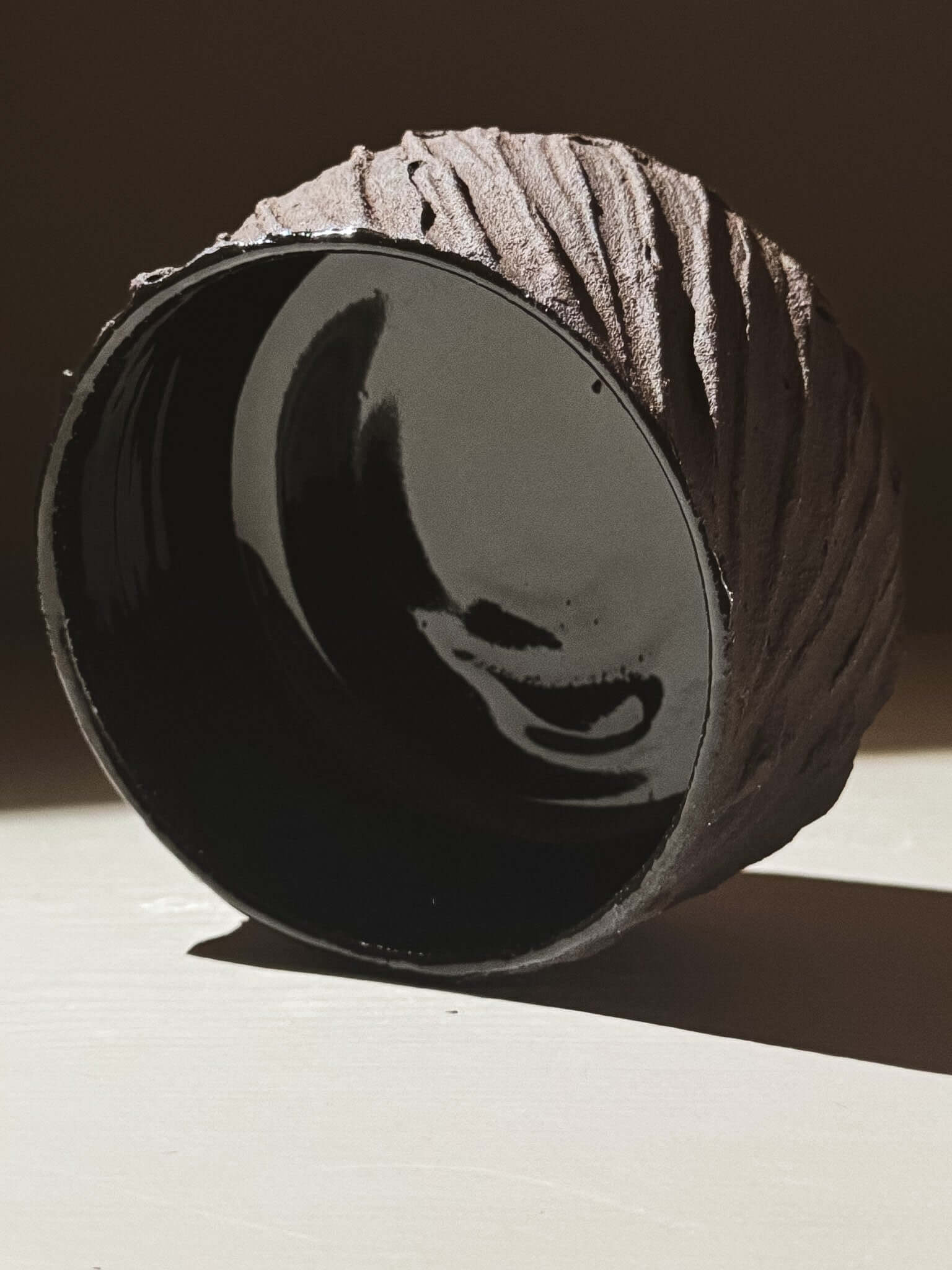 Kuro Matcha Bowl #01 with textured dark brown exterior and glossy black interior inspired by volcanic stone and earthy textures.