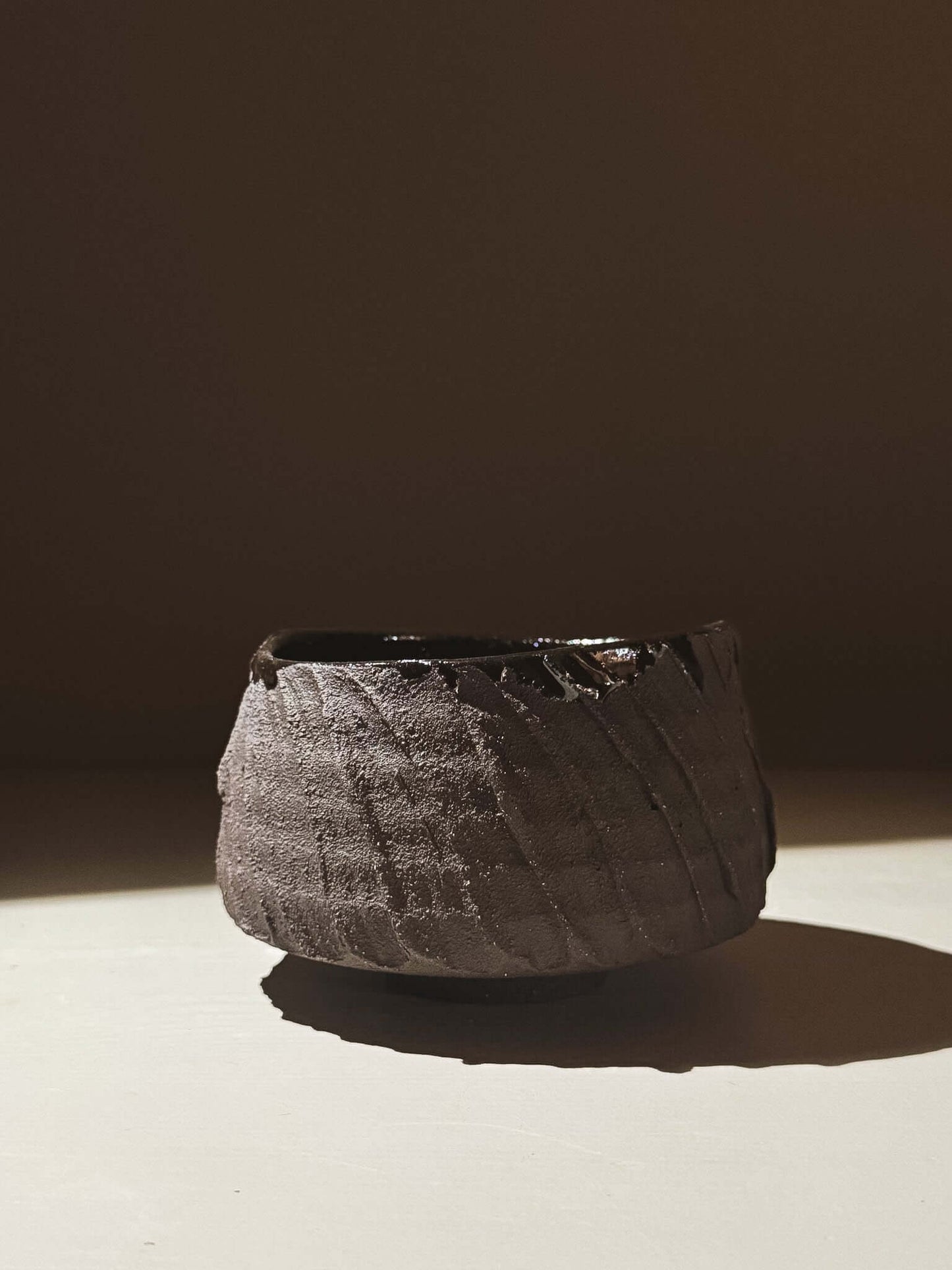 Kuro Matcha Bowl #02 with textured dark brown slip and glossy interior, inspired by volcanic stone and earthy textures.