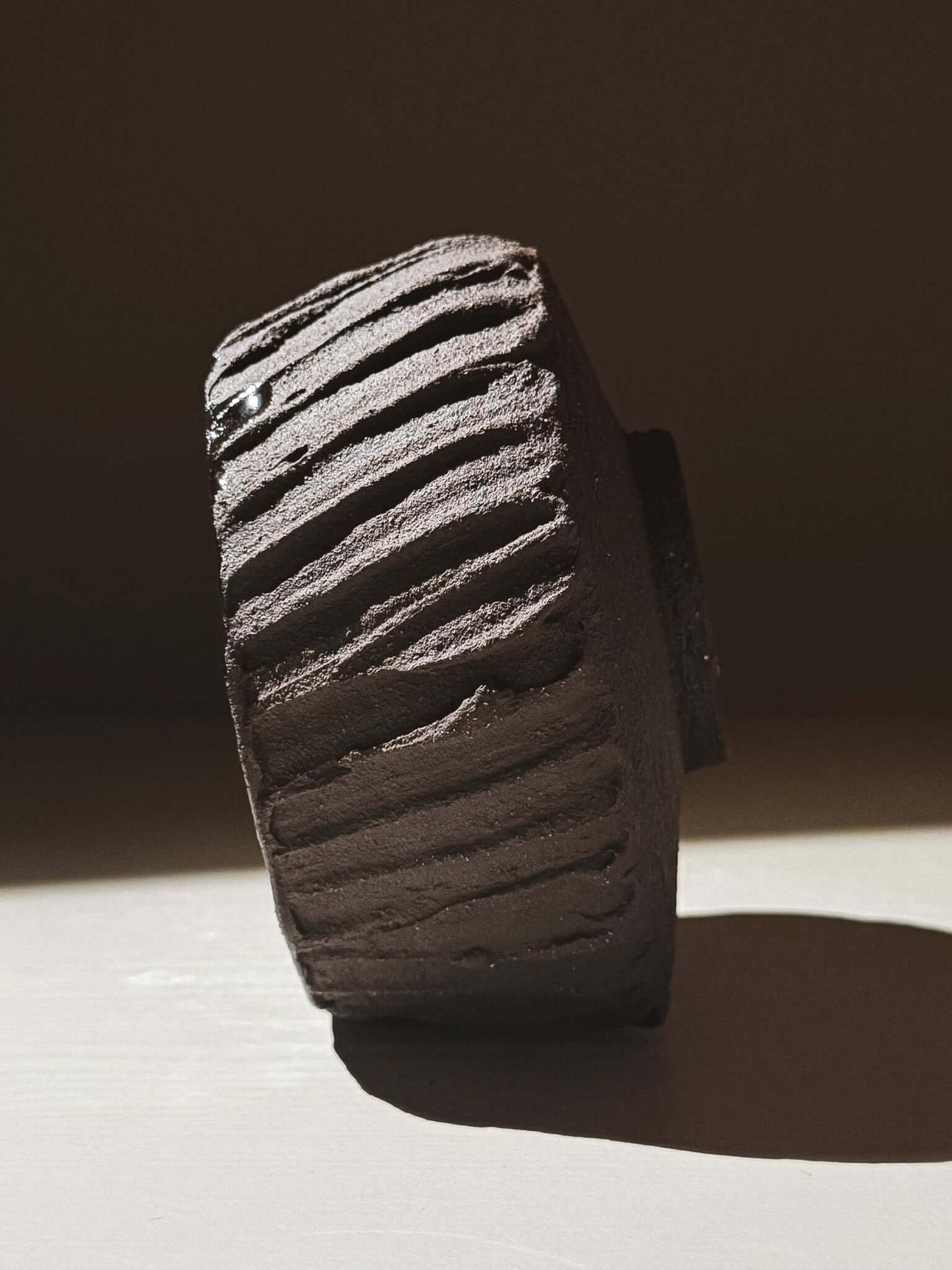 Kuro Matcha Bowl #03 with textured dark brown exterior and glossy interior, inspired by volcanic stone and earthy textures.