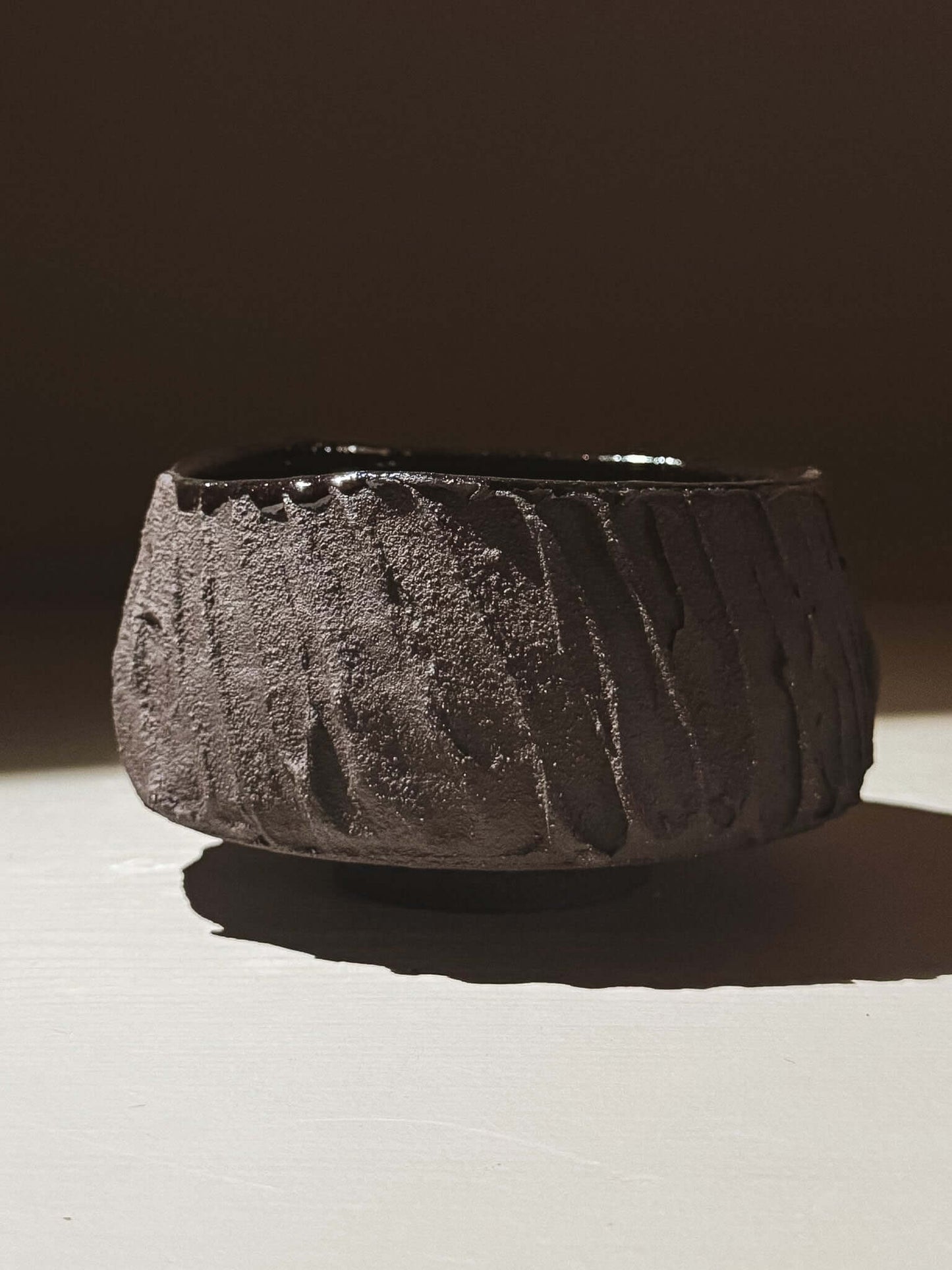 Kuro Matcha Bowl #03 with textured dark brown exterior and glossy interior, inspired by volcanic stone and natural tones.