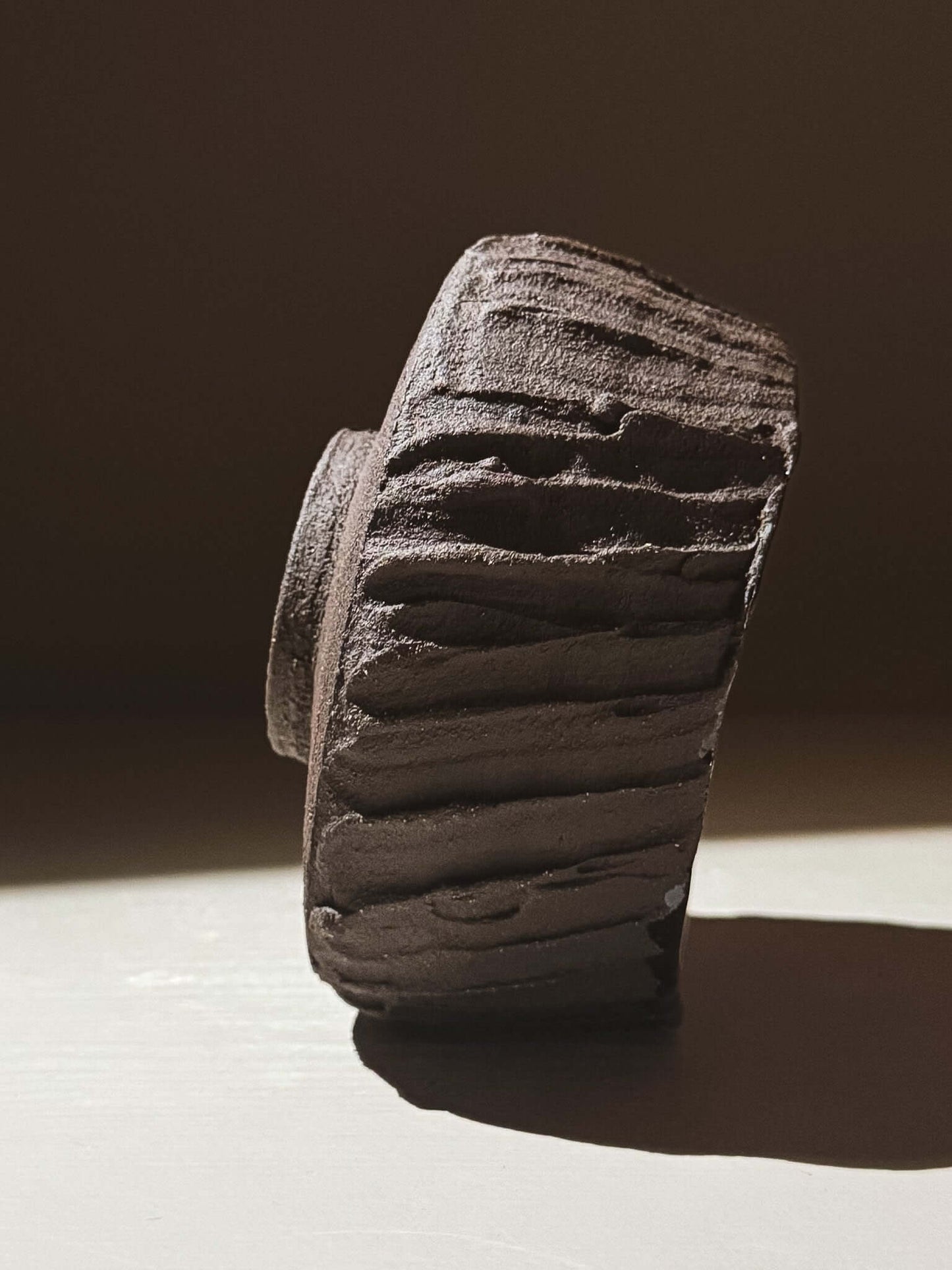 Kuro Matcha Bowl #03 with textured dark brown slip inspired by volcanic stone, showcasing earthy design and deep glazed finish.