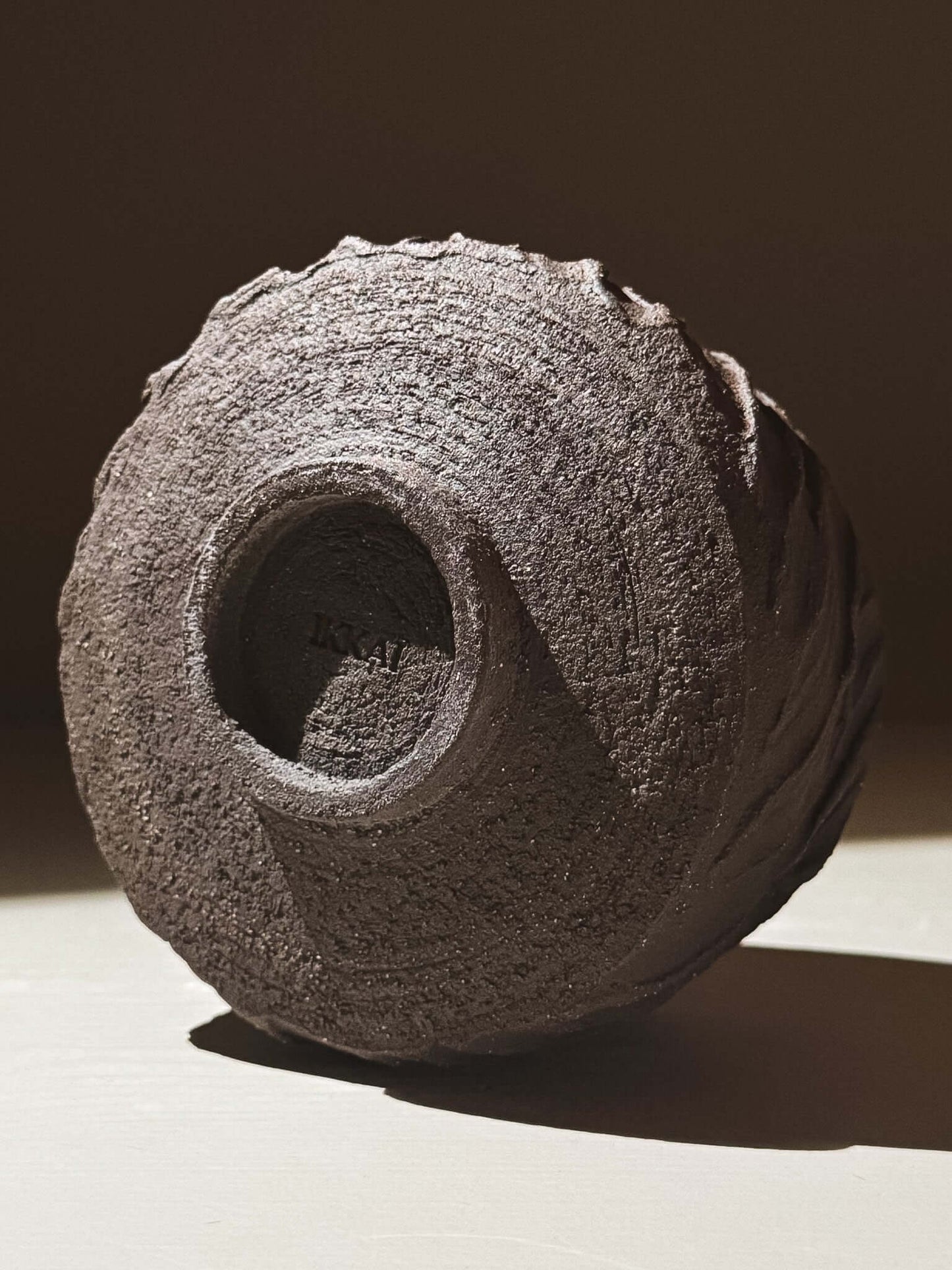 Kuro Matcha Bowl #04 featuring textured dark brown slip and glossy dark glaze, highlighting volcanic inspired design.