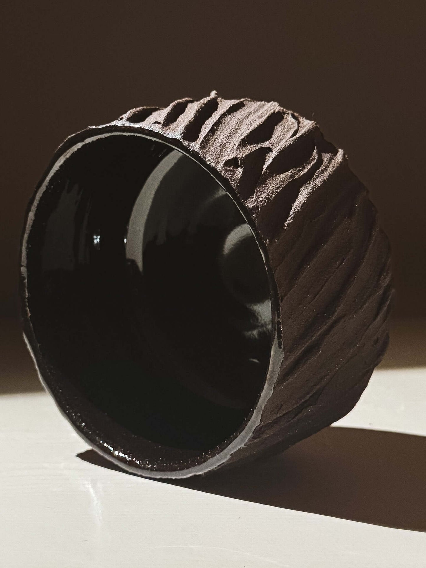 Kuro Matcha Bowl #06 with textured dark brown exterior and glossy interior reflecting light.