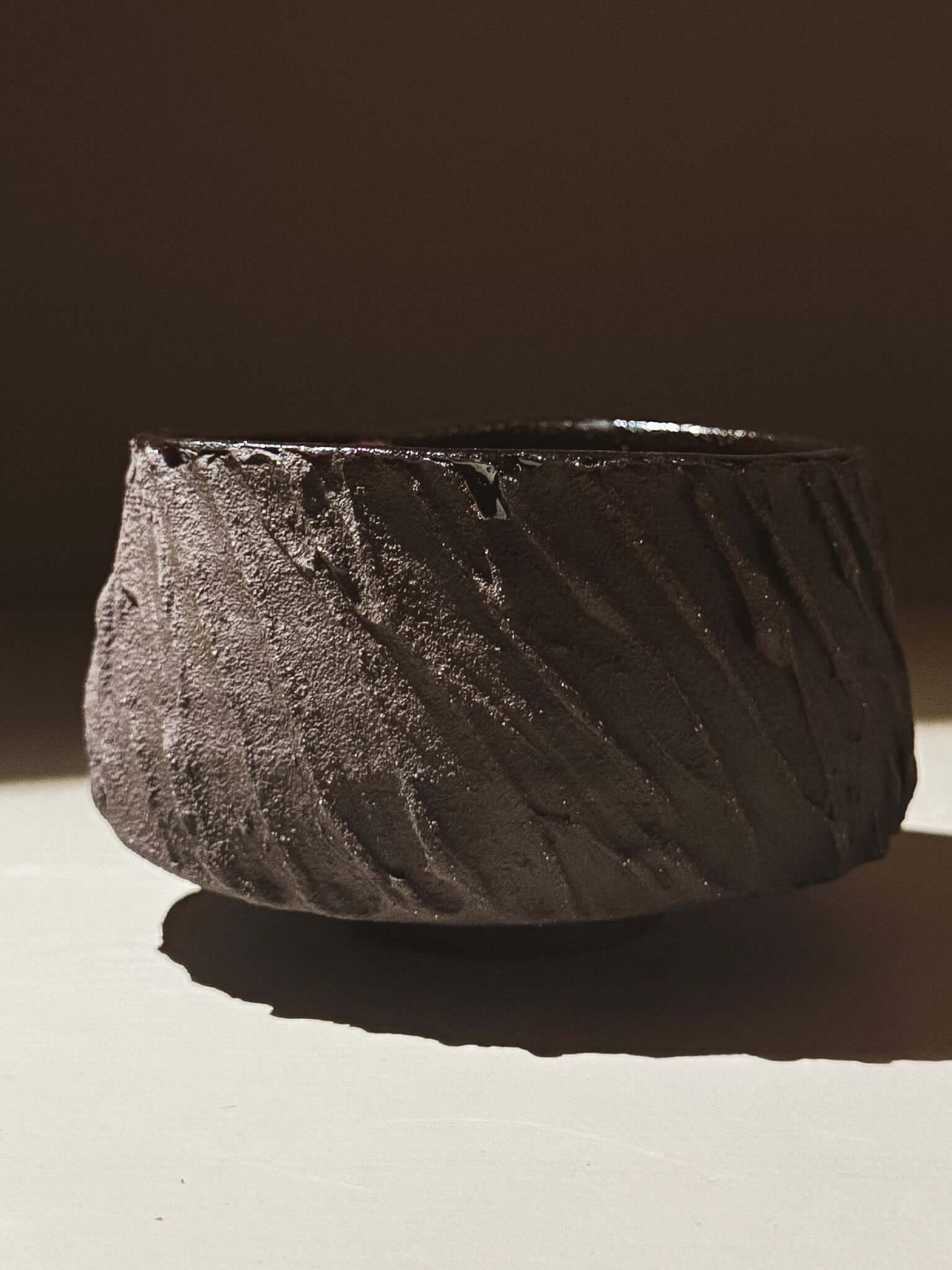 Kuro Matcha Bowl #06 with textured dark brown exterior and glossy dark interior, inspired by volcanic stone and natural tones