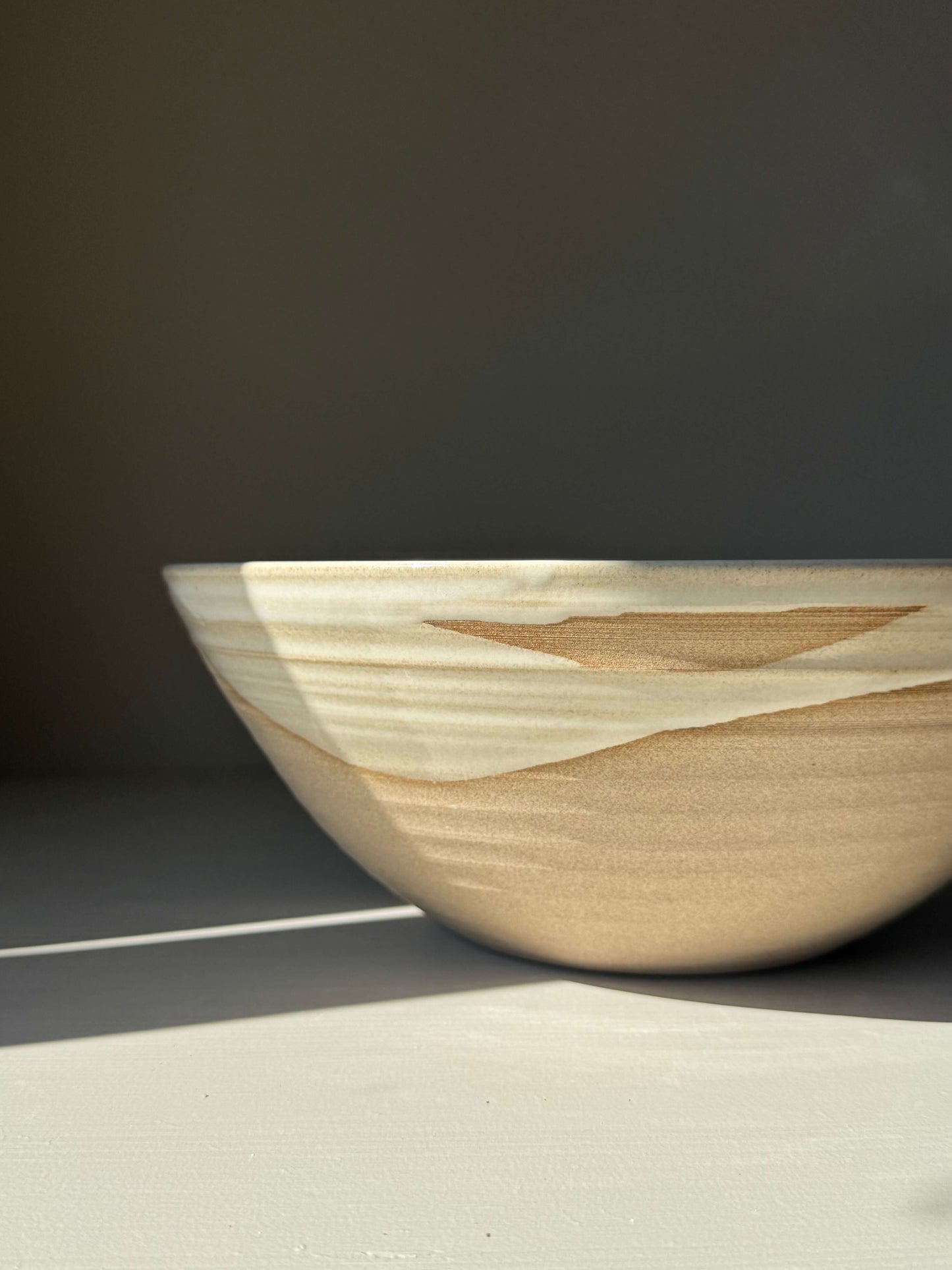 Large Bowl - Yuki handmade ceramic with white glaze over raw clay in sunlight