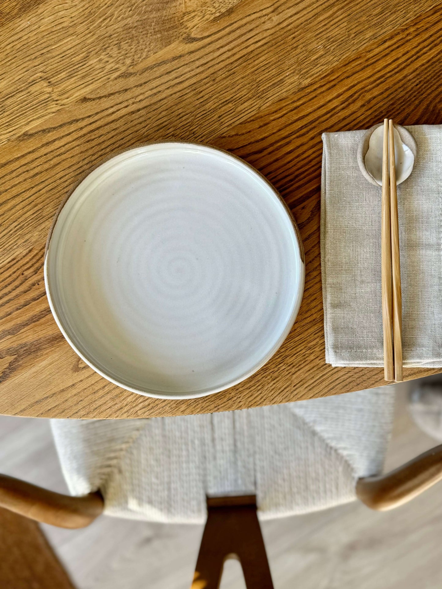 Large Plate – Yuki, handmade ceramic plate on wooden table, featuring white glossy glaze, warm toffee clay, part of Yuki Series.