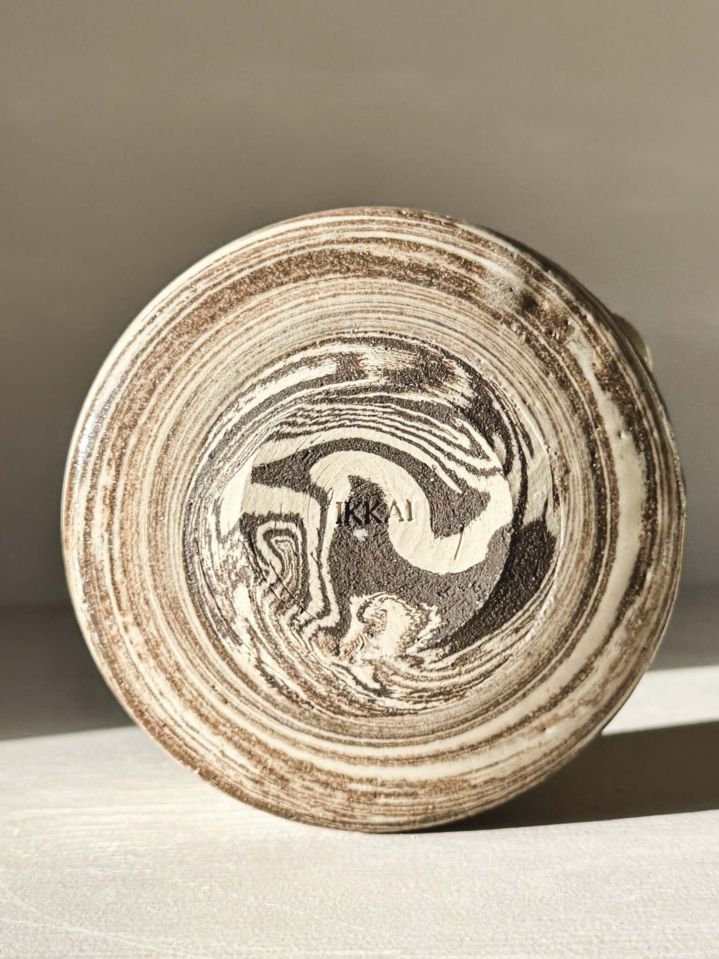 Bottom view of Matcha Bowl Spout - Marbled #01 with natural clay swirls