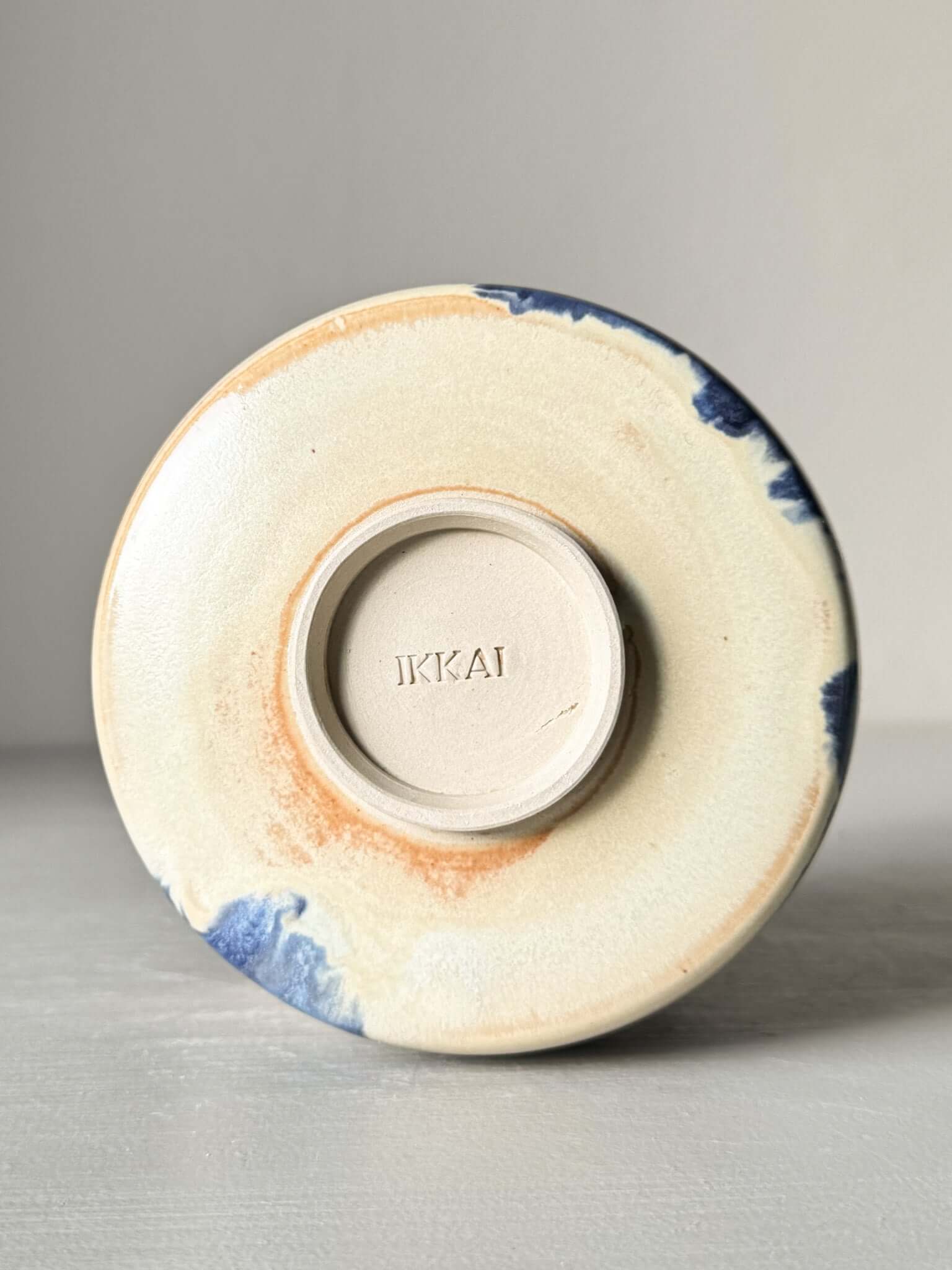 Bottom view of Matcha bowl Spout - Moonstone & Blue #03 showcasing hand-splashed cobalt glaze and moonstone finish.