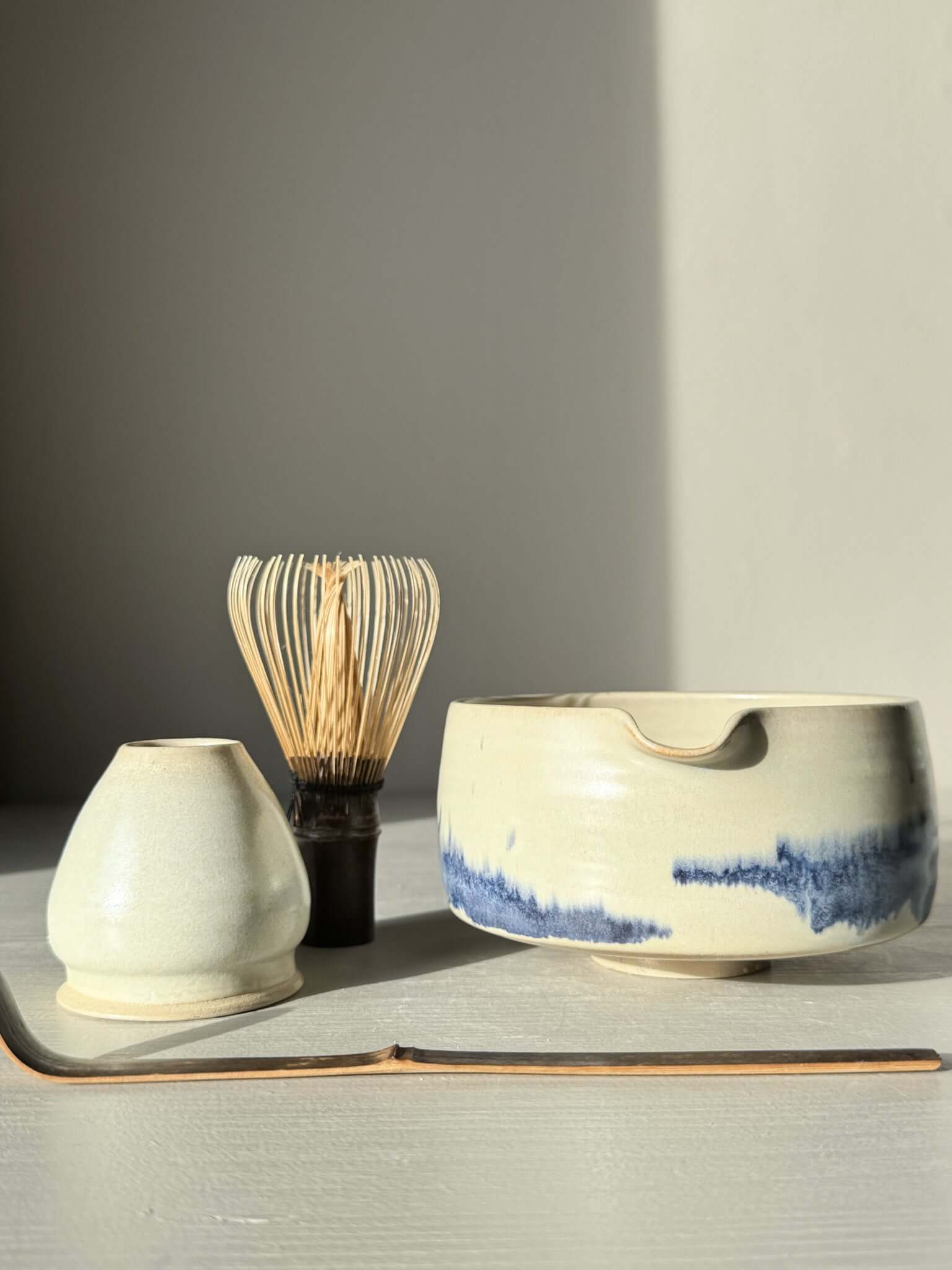Matcha bowl Spout - Moonstone & Blue #02 with bamboo whisk and tea set on a light background
