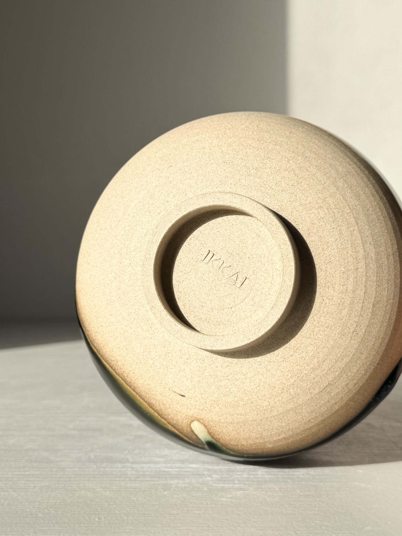 Underside of the Matcha Bowl with Spout – Mori #05, showcasing handmade ceramic design and unique glaze patterns.