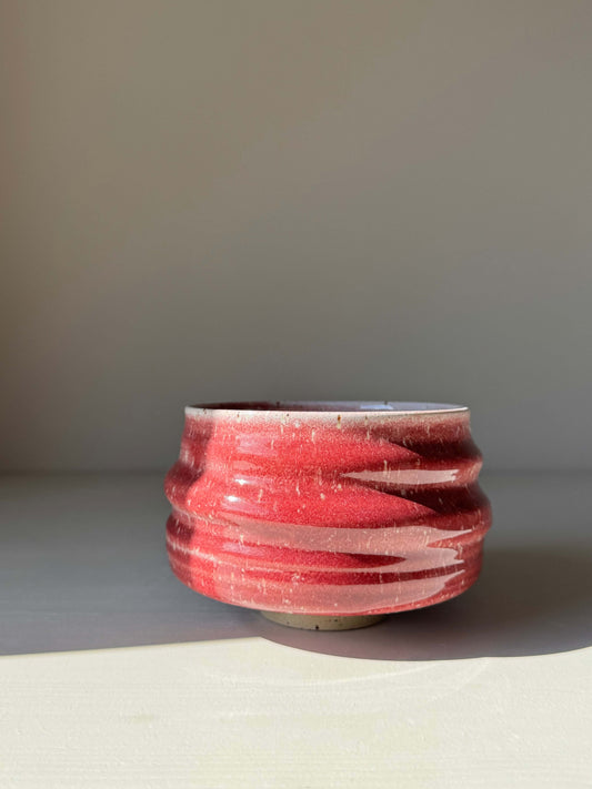 Handmade ceramic Matcha Bowl - Ume Series #08 with red glaze, inspired by Japanese Ume blossom, featuring rounded shape and flowing ridges.