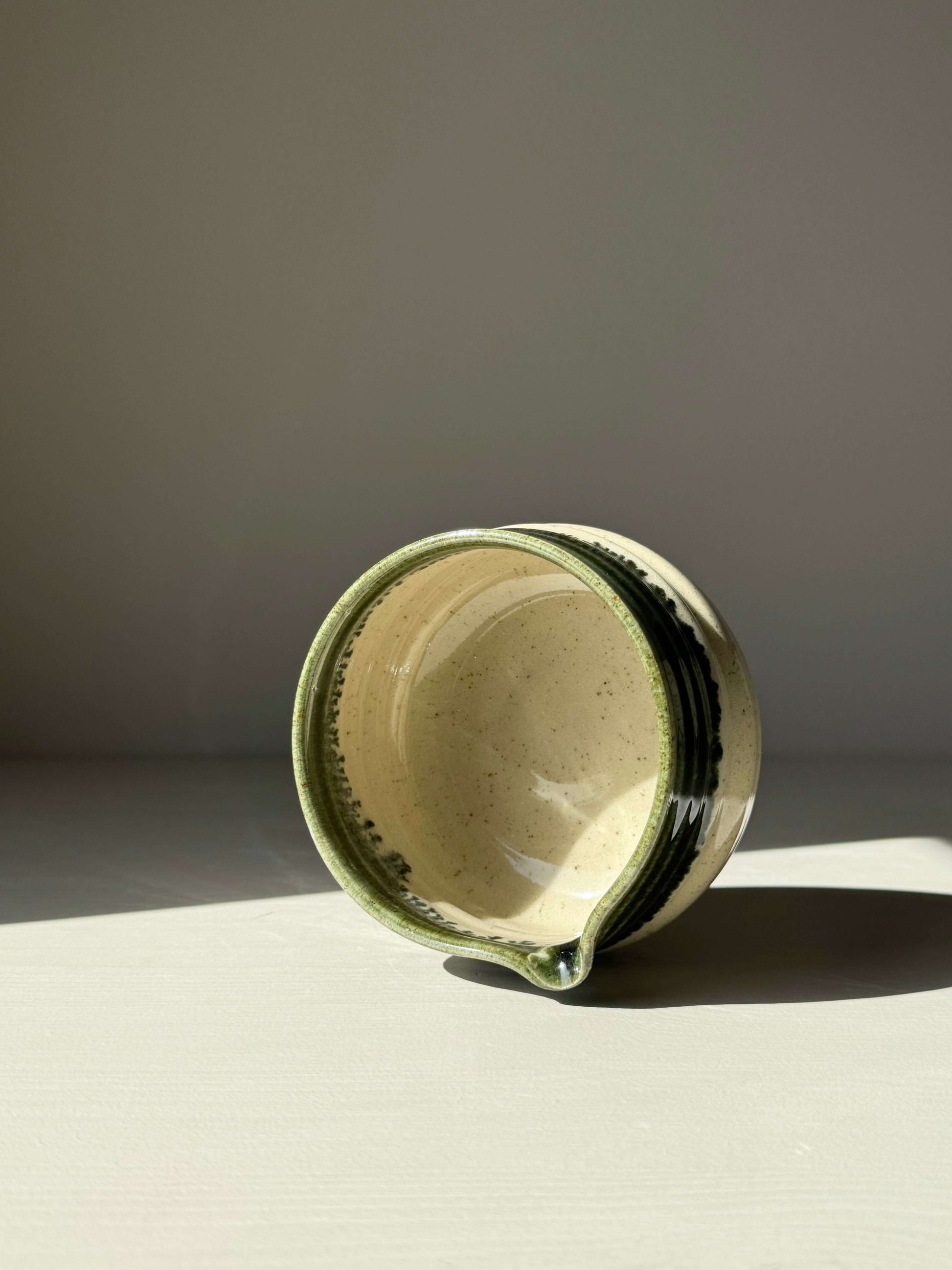 Handcrafted matcha bowl with spout, featuring a glossy green rim and subtle ridges for easy handling, perfect for whisking matcha.