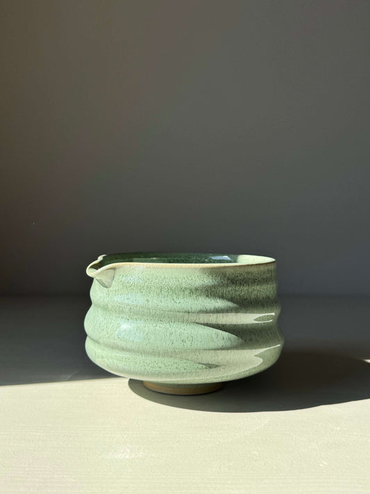 Sage glaze matcha bowl with spout, showcasing unique ridged design and glossy finish for easy whisking and elegant presentation.