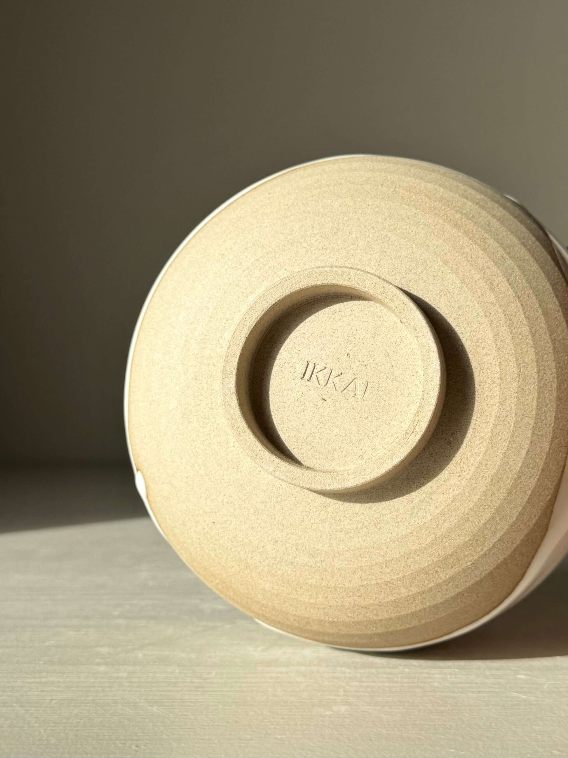 Underside view of the handmade ceramic Matcha Bowl with Spout – Yuki #04 showcasing toffee clay texture.