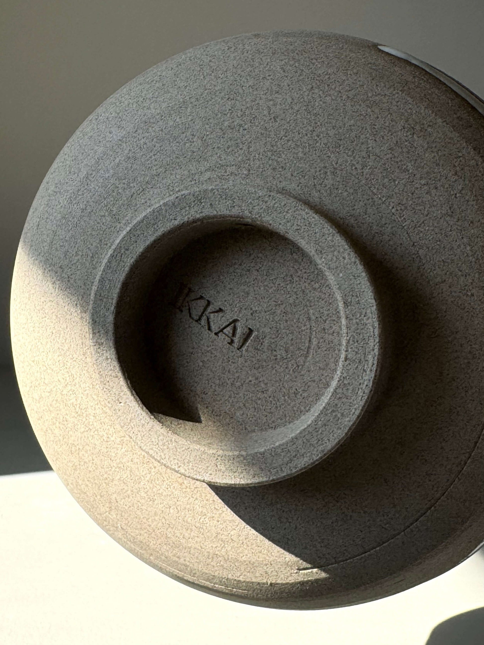 Underside view of a handmade Matcha bowl with 'KAI' embossed, showcasing toffee clay texture from the Yuki Series #09.