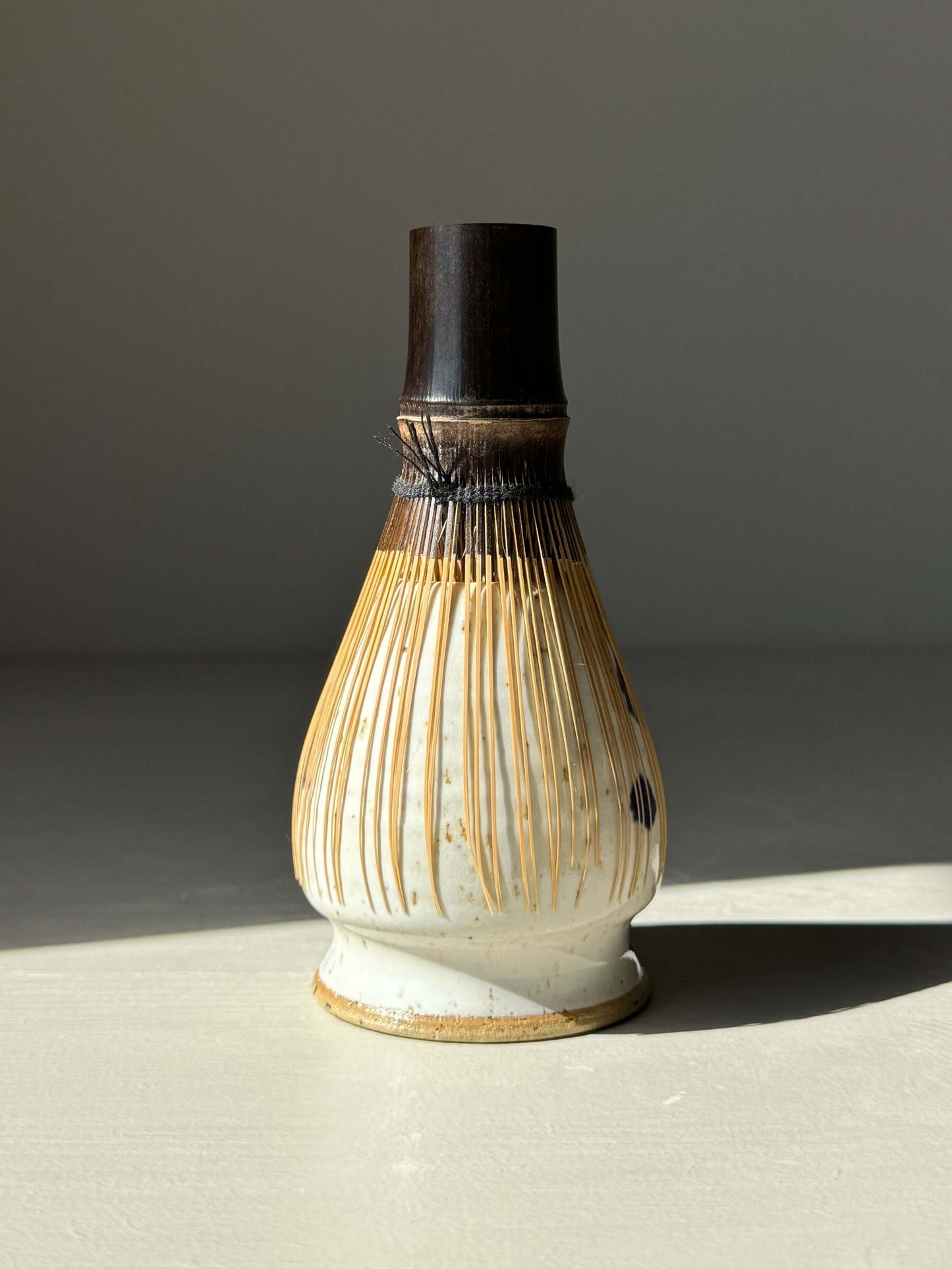 Cobalt blue and glossy white matcha whisk holder with unique cobalt splashes, designed to keep bamboo chasen tines in shape.