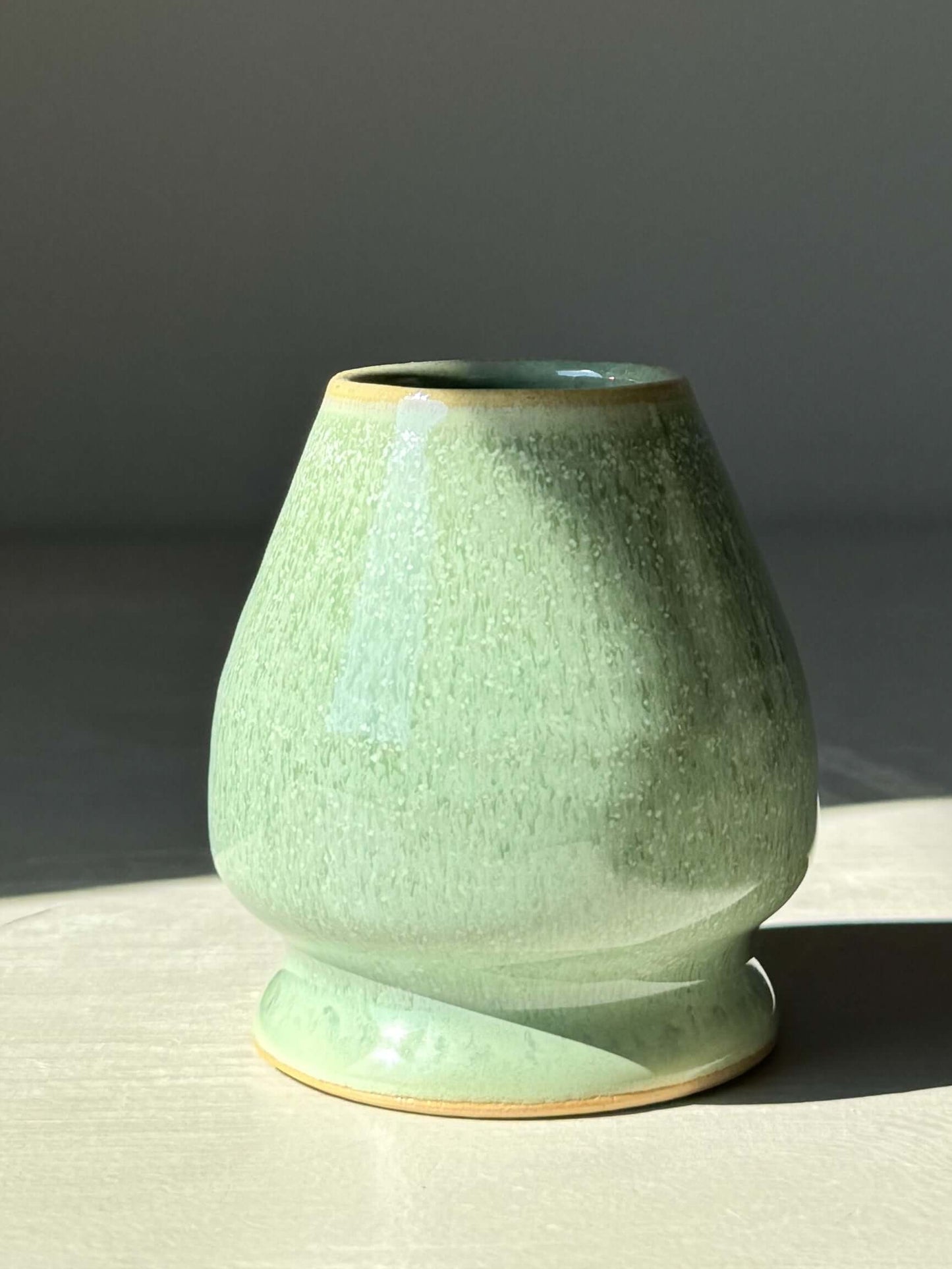 Sage glaze matcha whisk holder, wheel-thrown ceramic, designed to preserve and dry bamboo whisk, adding serenity to matcha moments.