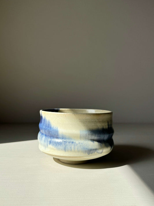Cobalt blue and moonstone glazed matcha bowl with a unique hand-splashed design, showcasing a rounded shape and serene aesthetic.