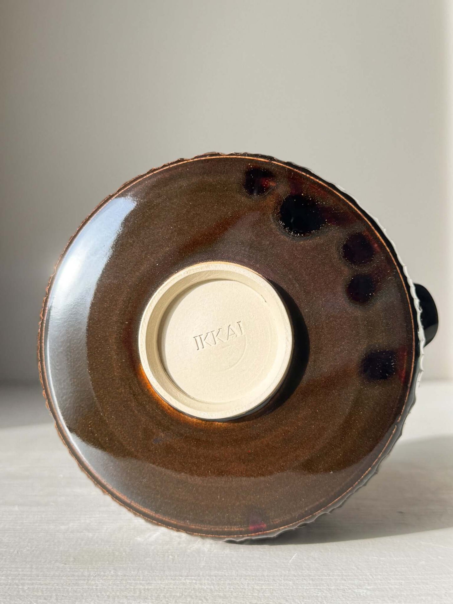 Bottom view of Matcha Bowl Spout – Kinsei #02 showing handcrafted glaze and IKAI imprint.