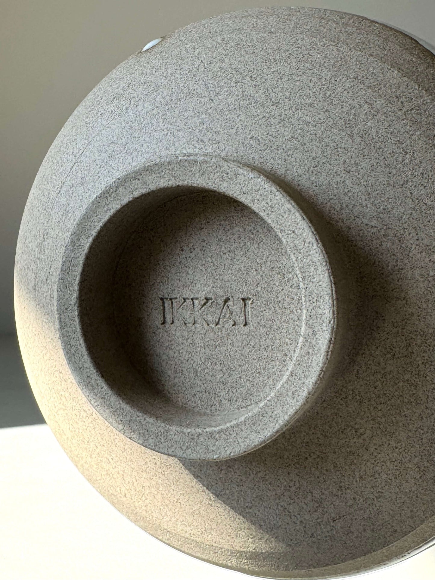 Base of Yuki Series Matcha Bowl with 'Yuki' stamp, showcasing textured toffee clay.