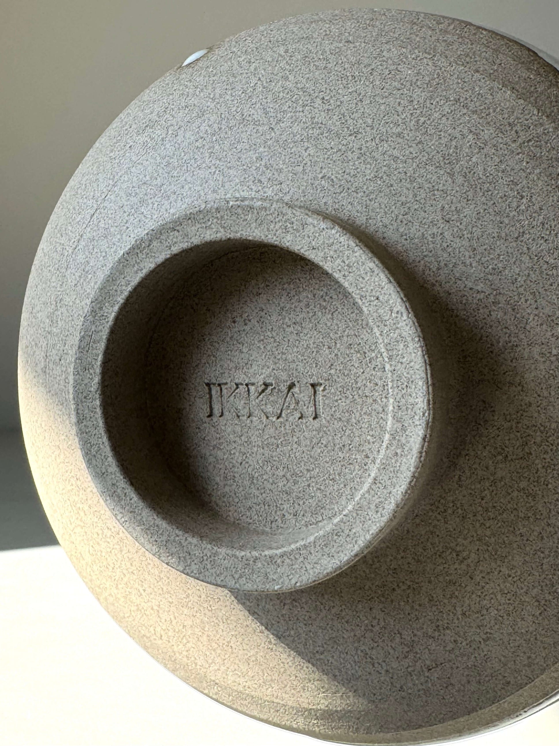 Base of Yuki Series Matcha Bowl with 'Yuki' stamp, showcasing textured toffee clay.