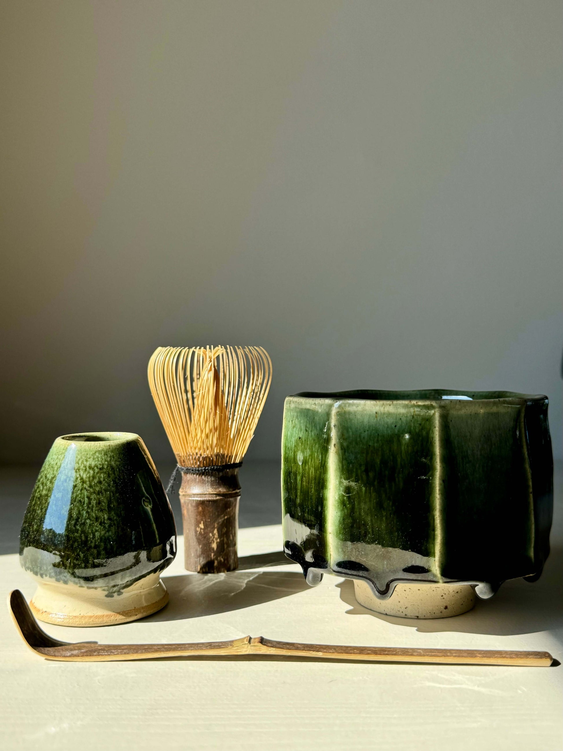 Green glazed Matcha whisk holder from Hinoki Series with bamboo whisk and accessories, embodying balance and tranquility.