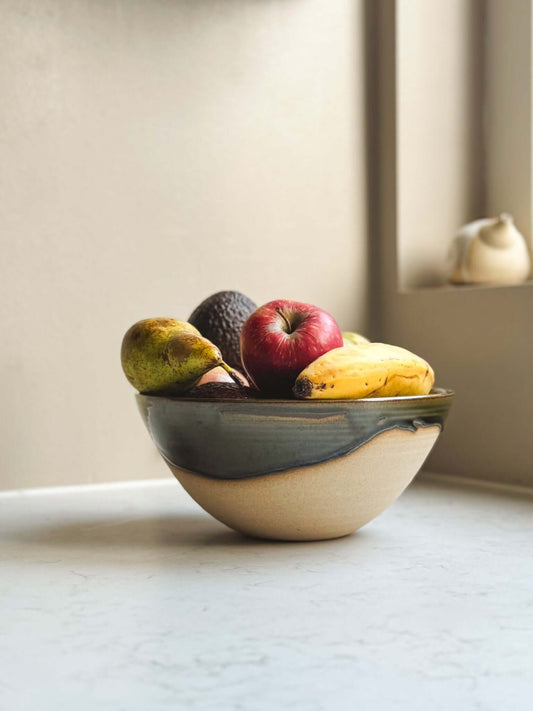 Medium Bowl - Mori #02 with green glaze, holding fruit on a white countertop
