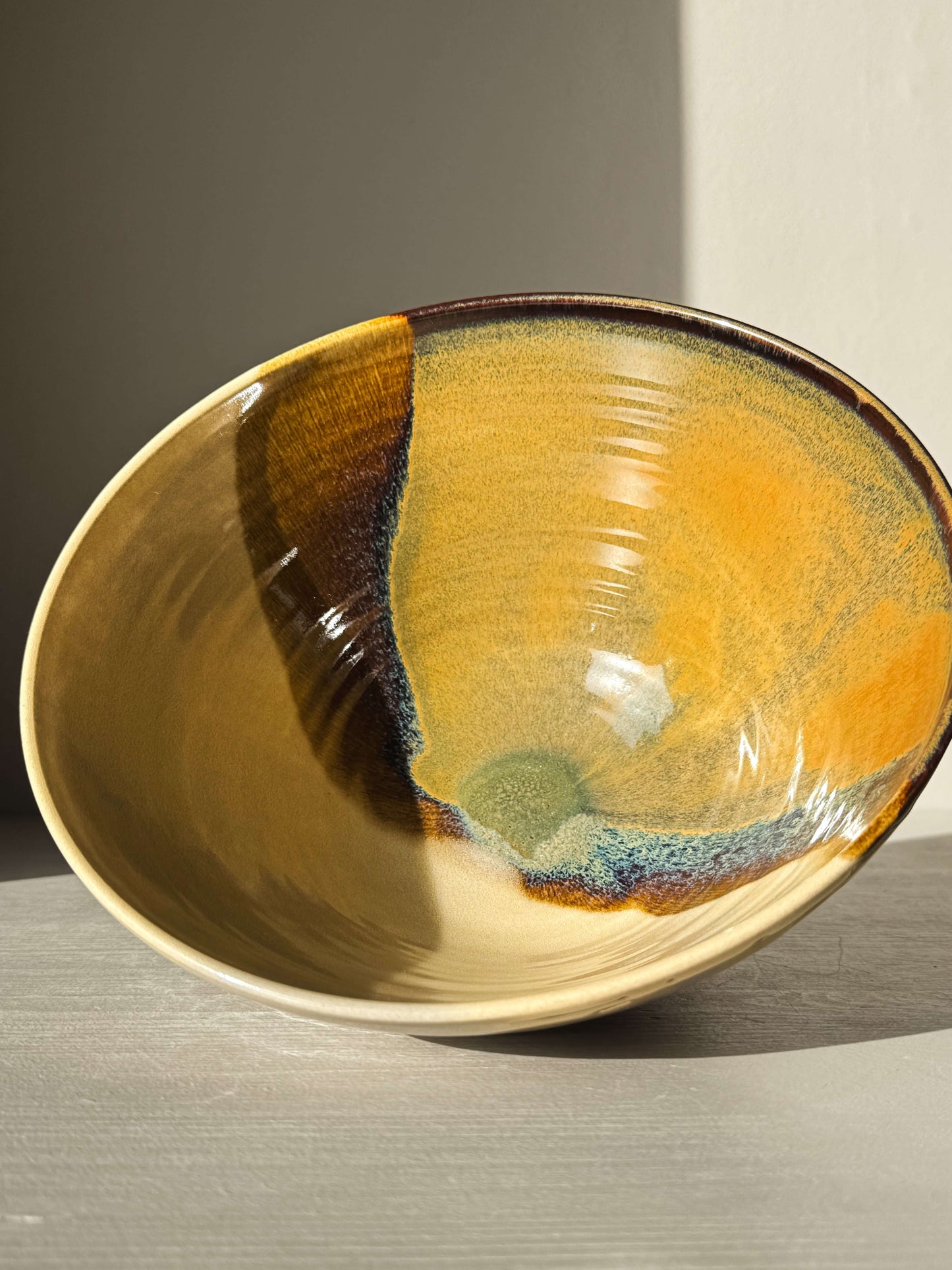 Medium Carved Bowl - Inyo #01 with golden tones, deep brown, soft blue, and green center, showcasing raw carved exterior and warm character.