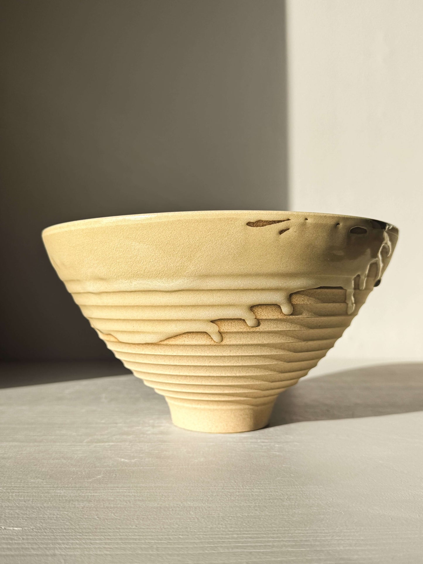 Medium Carved Bowl - Inyo #01 with a sculptural design, golden brown tones, and a carved exterior with drips along the rim.