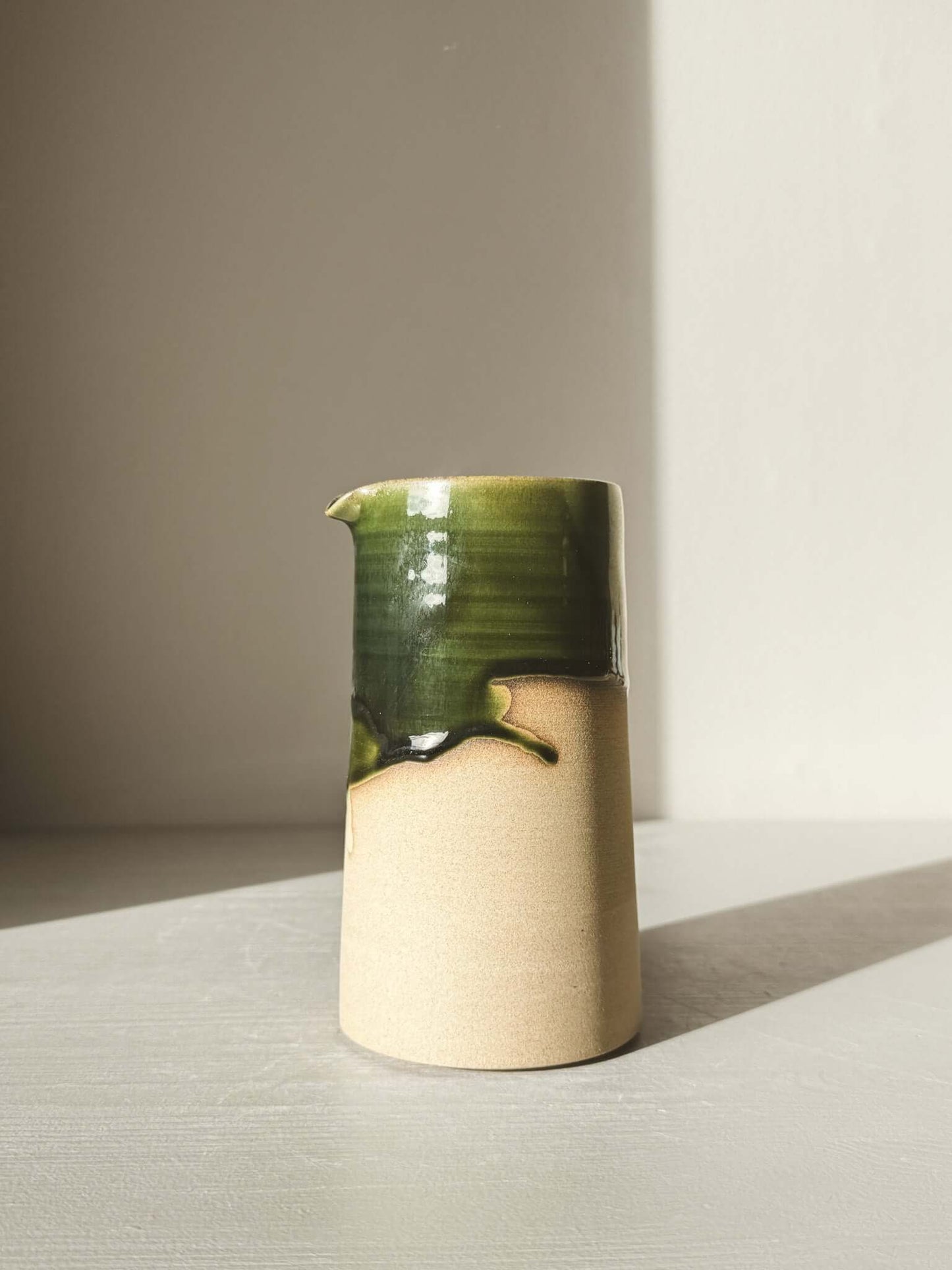 Medium Vase/Jug – Mori #01 with green glaze, showcasing a sculptural design and natural feel.