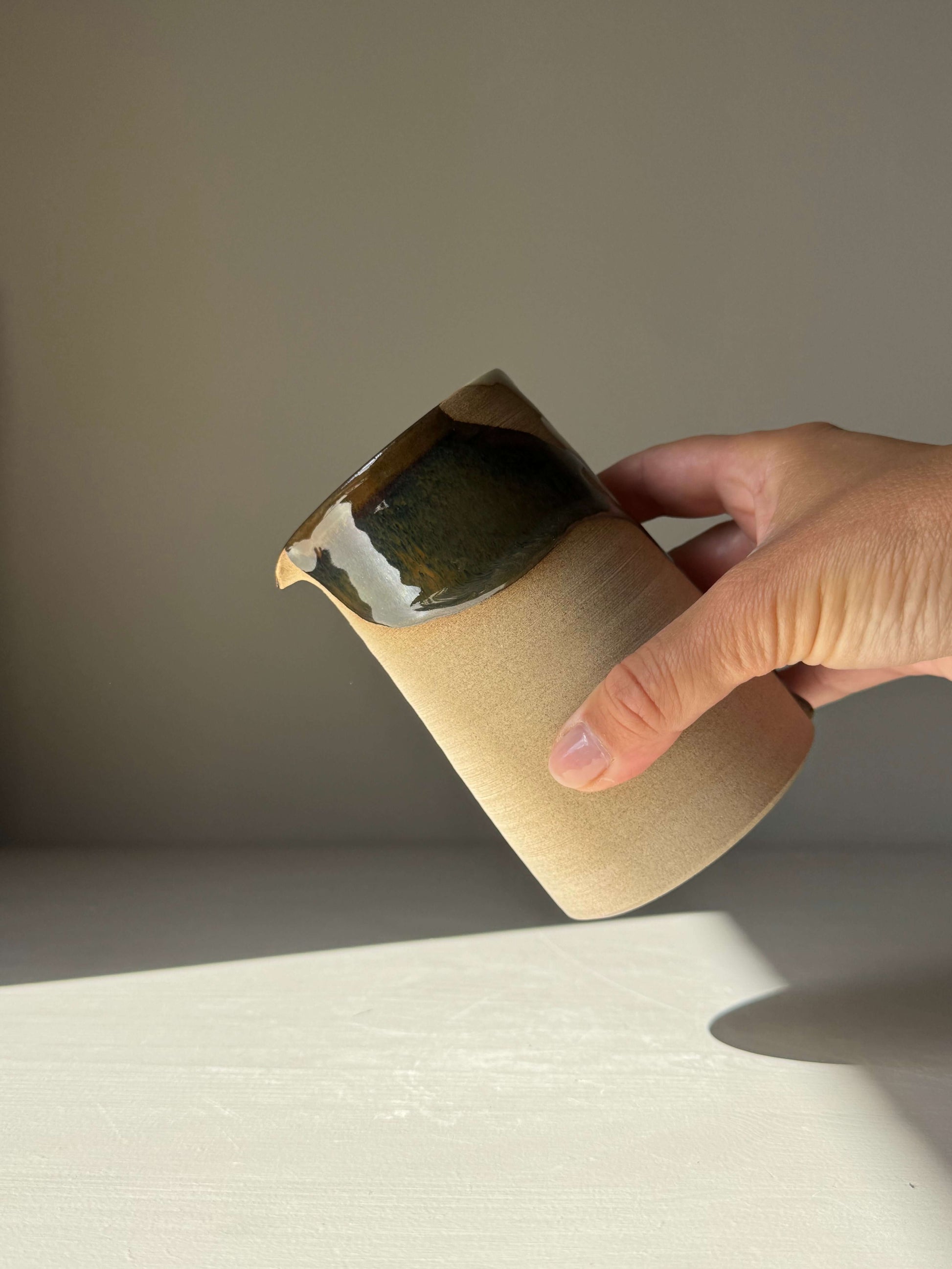 Hand holding Medium Vase / Jug – Inyo Series with raw and glazed ceramic texture, suitable for home decor or studio use.