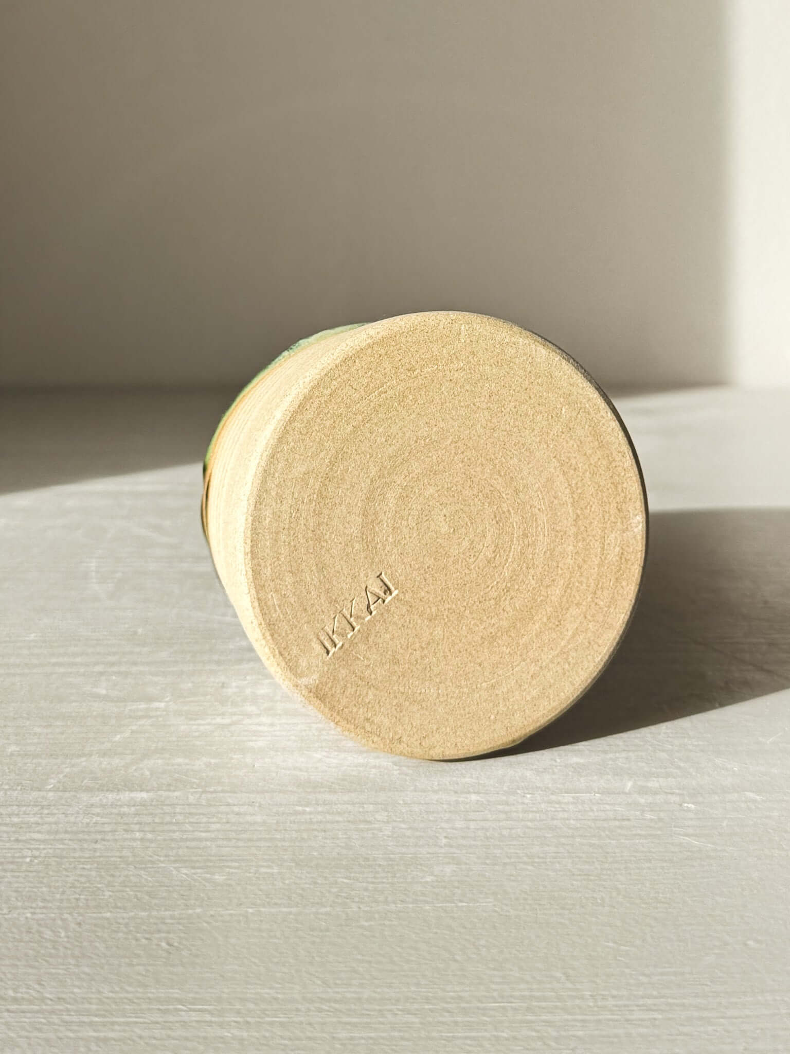 Base view of Medium Vase – Mori #02 with textured clay finish on a sunlit surface, showcasing craftsmanship and design.