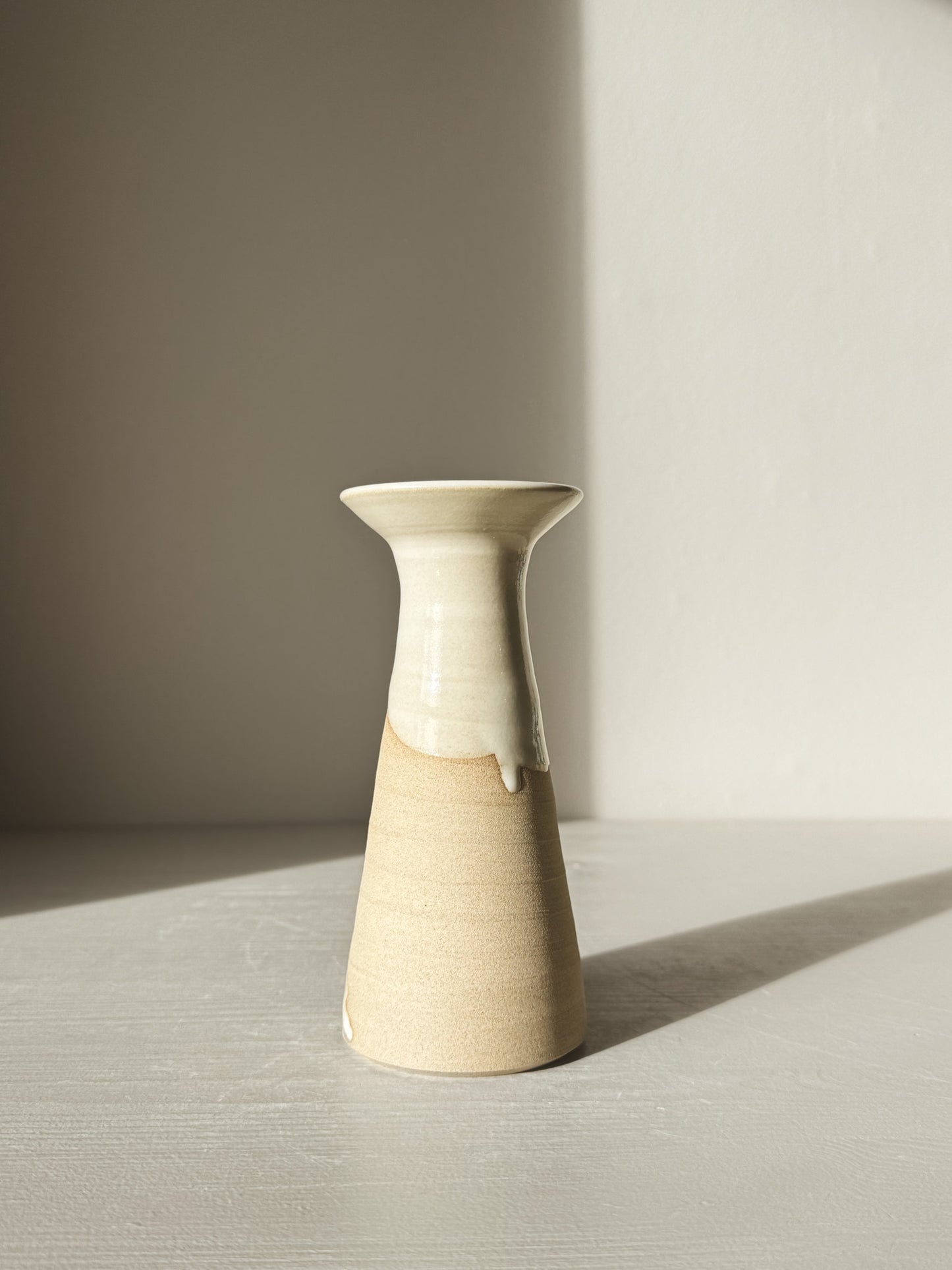 Medium Vase – Yuki #01 with tapered waist and glossy white glaze on stoneware, showcasing elegant design in natural light.
