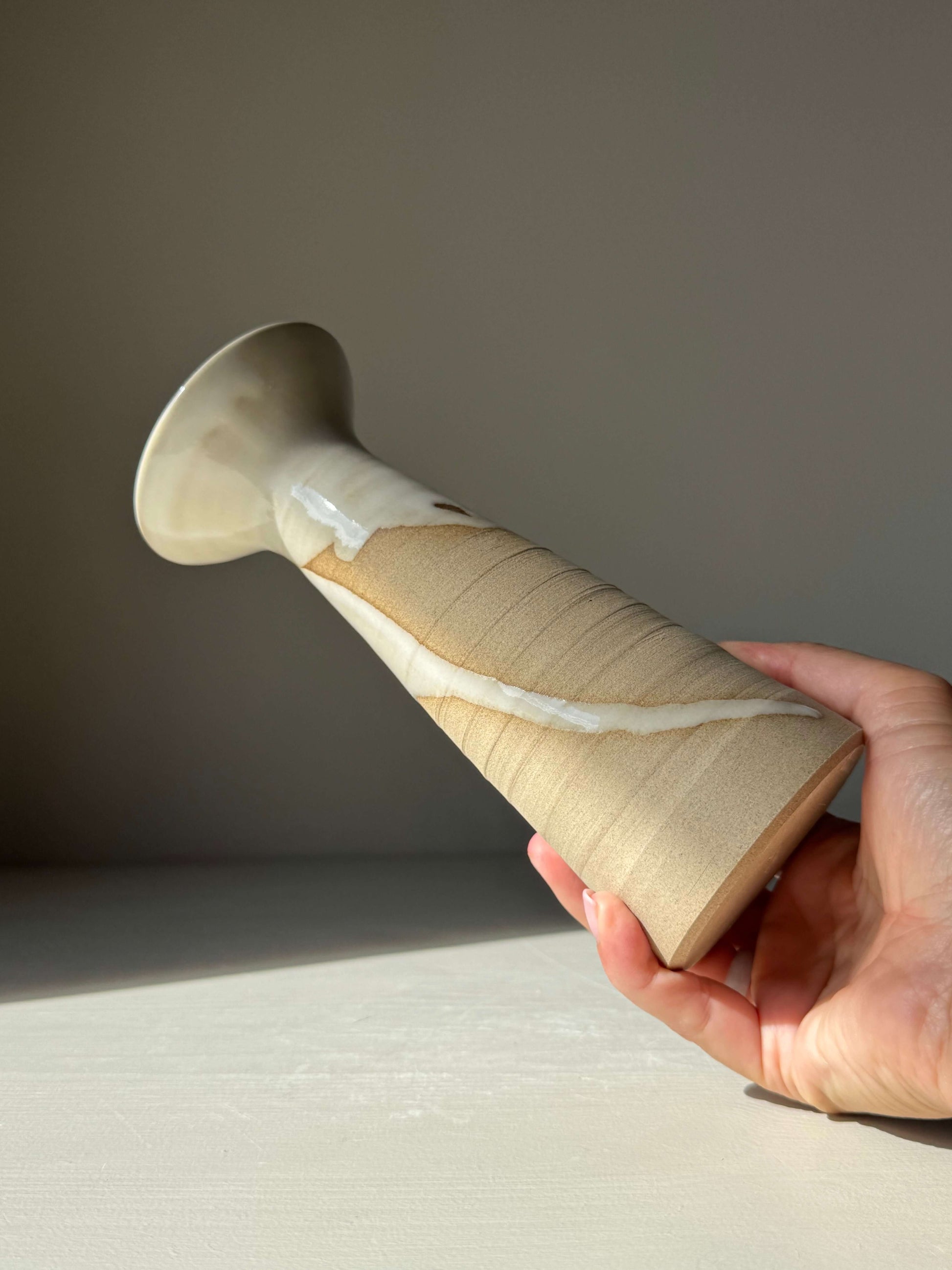 Hand holding Medium Vase – Yuki Series #02, a handmade ceramic vase with glossy white glaze and natural patterns on warm stoneware.